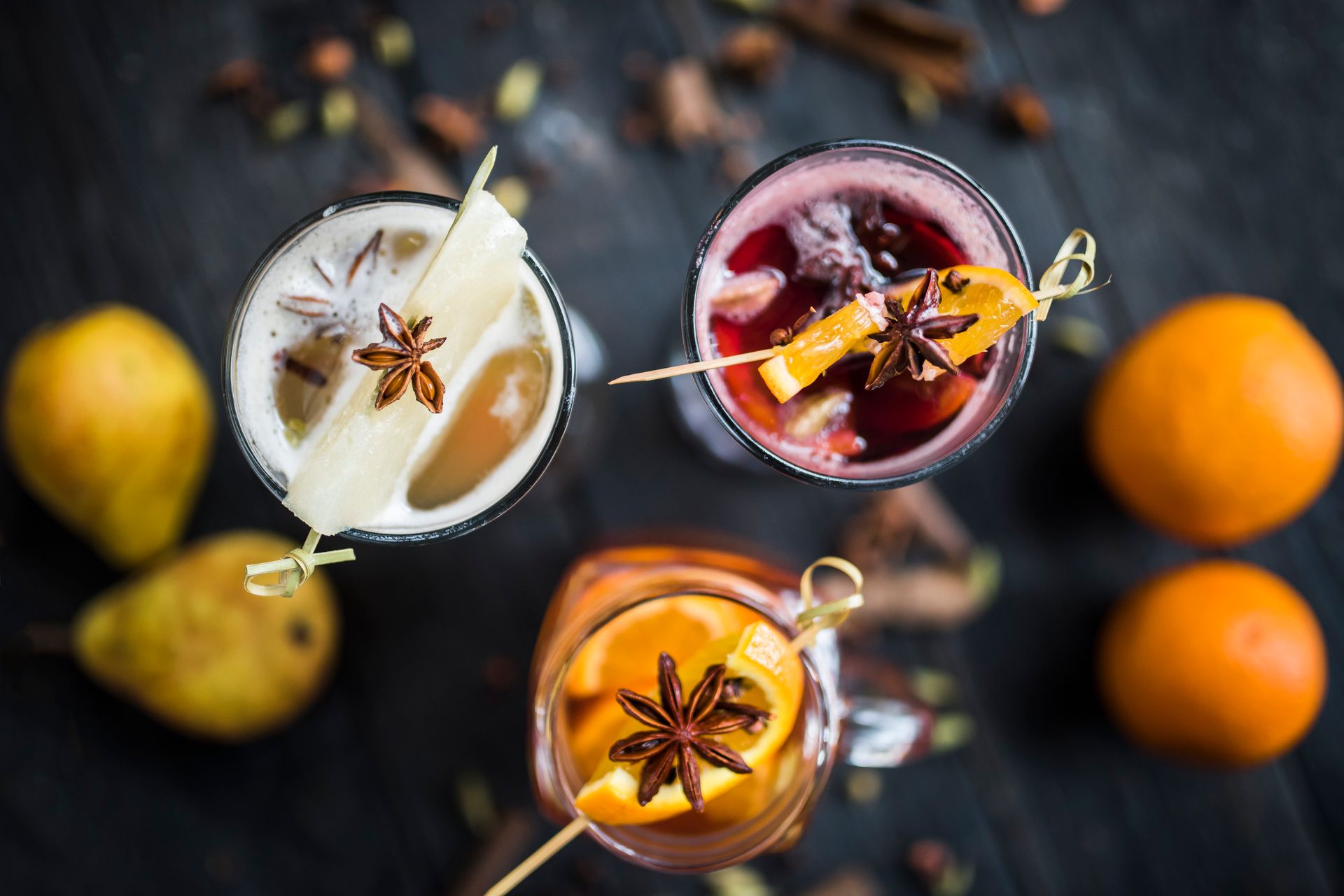 Assorted beverages of spiced wine with fruit garnish