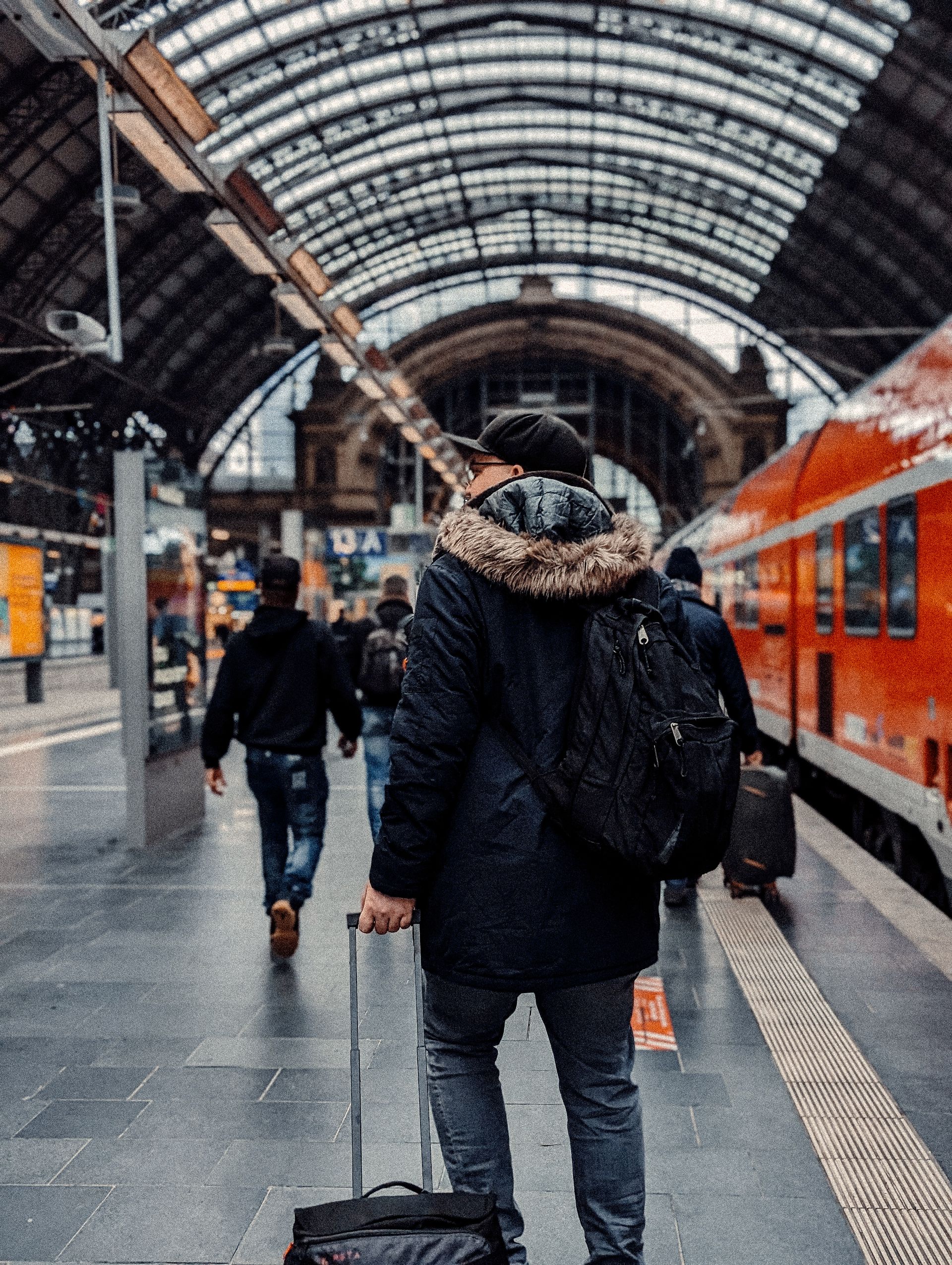 Traveler with backpack and suitcase at Frankfurt train station