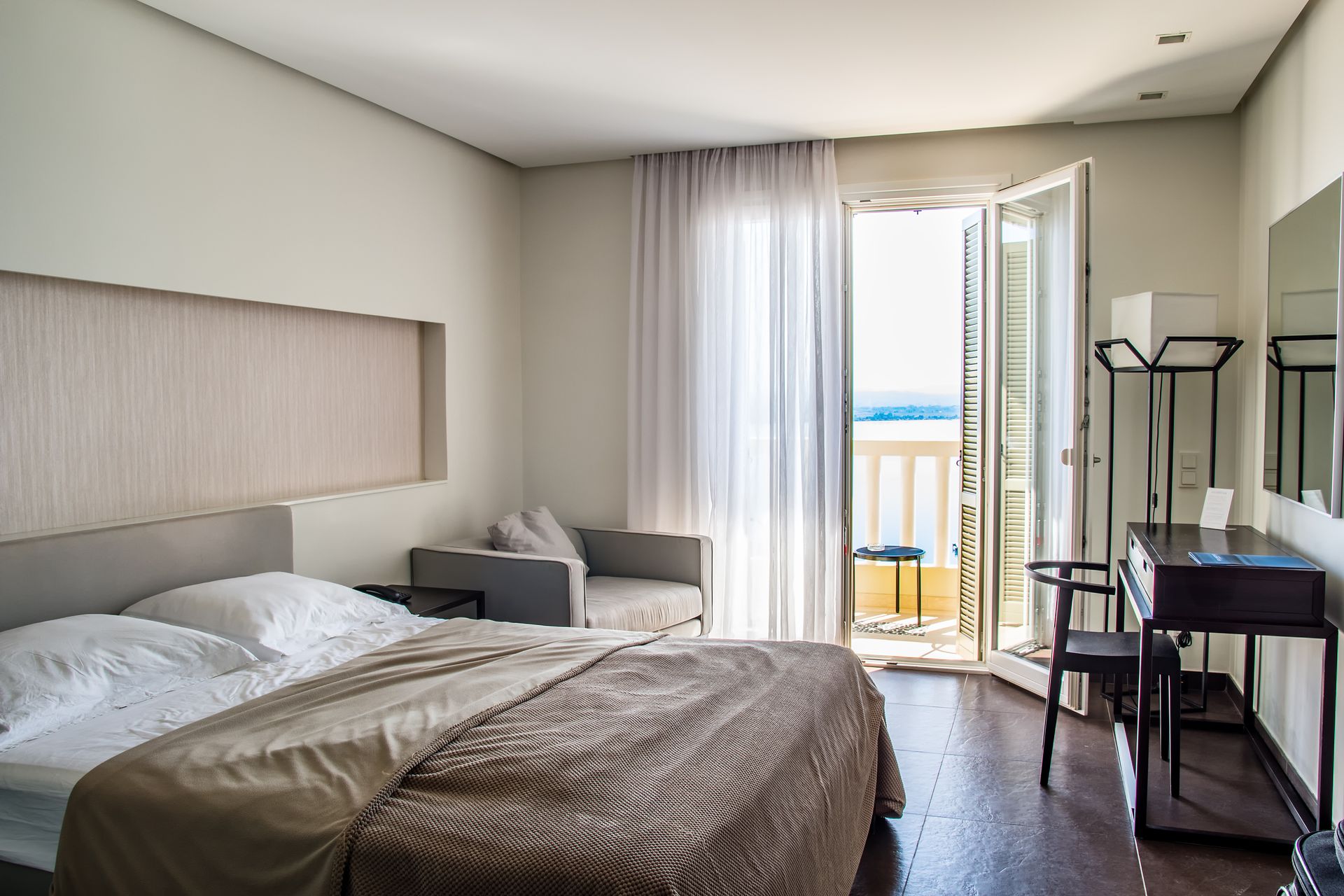 Elegant hotel room with balcony and sea view
