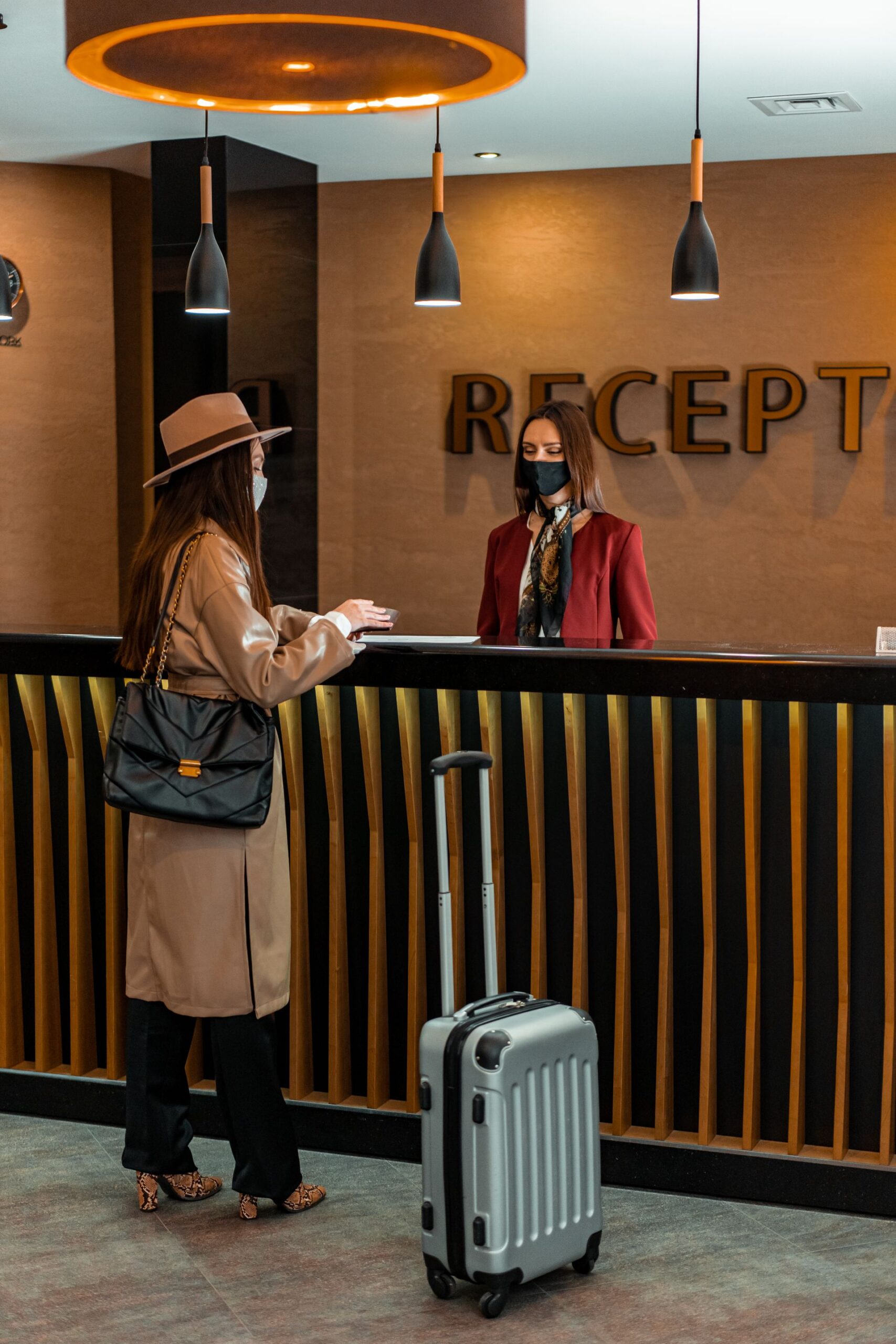 Businesswoman checking in at a stylish hotel reception