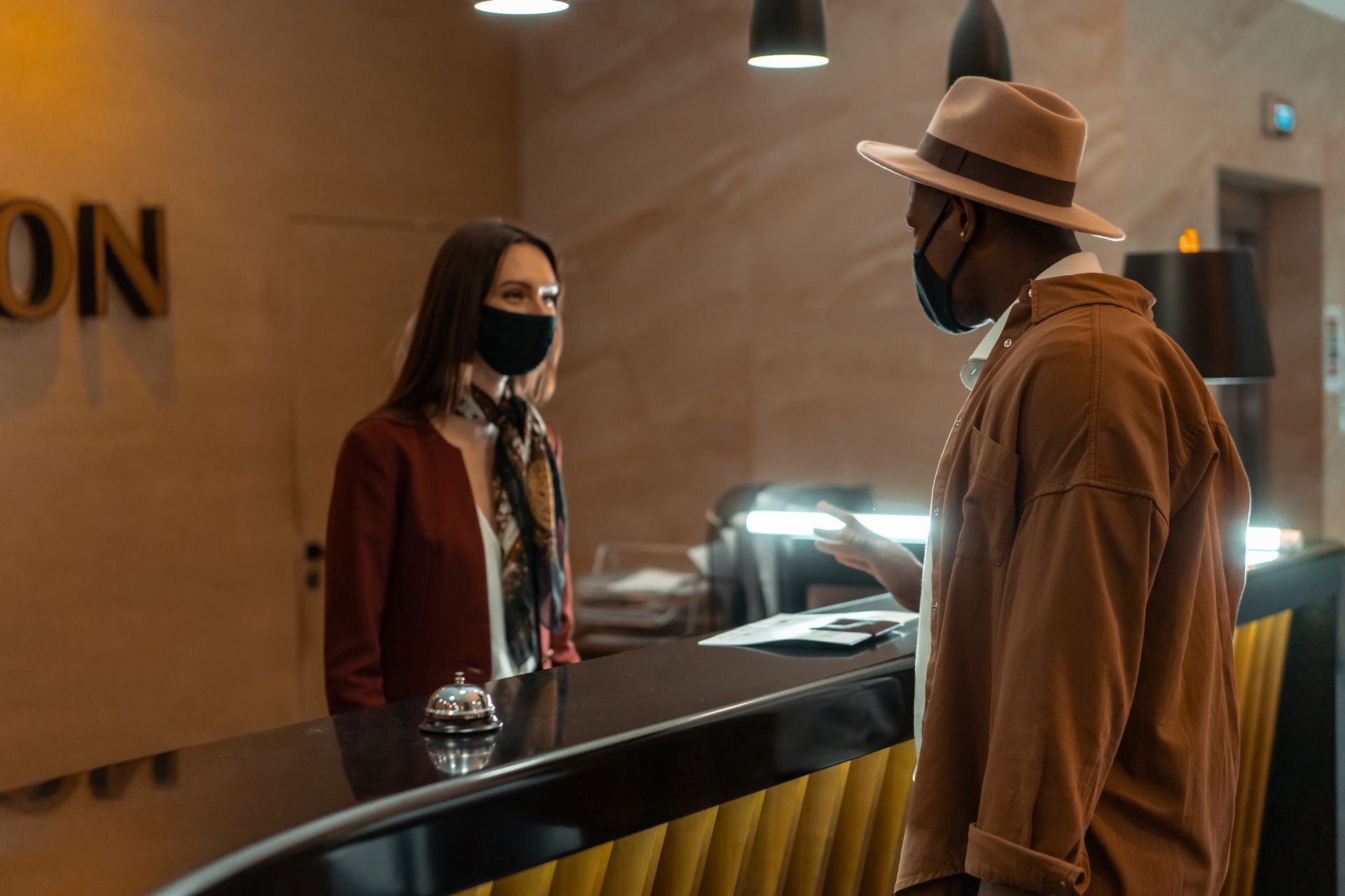 Guest talking to hotel reception staff at the front desk