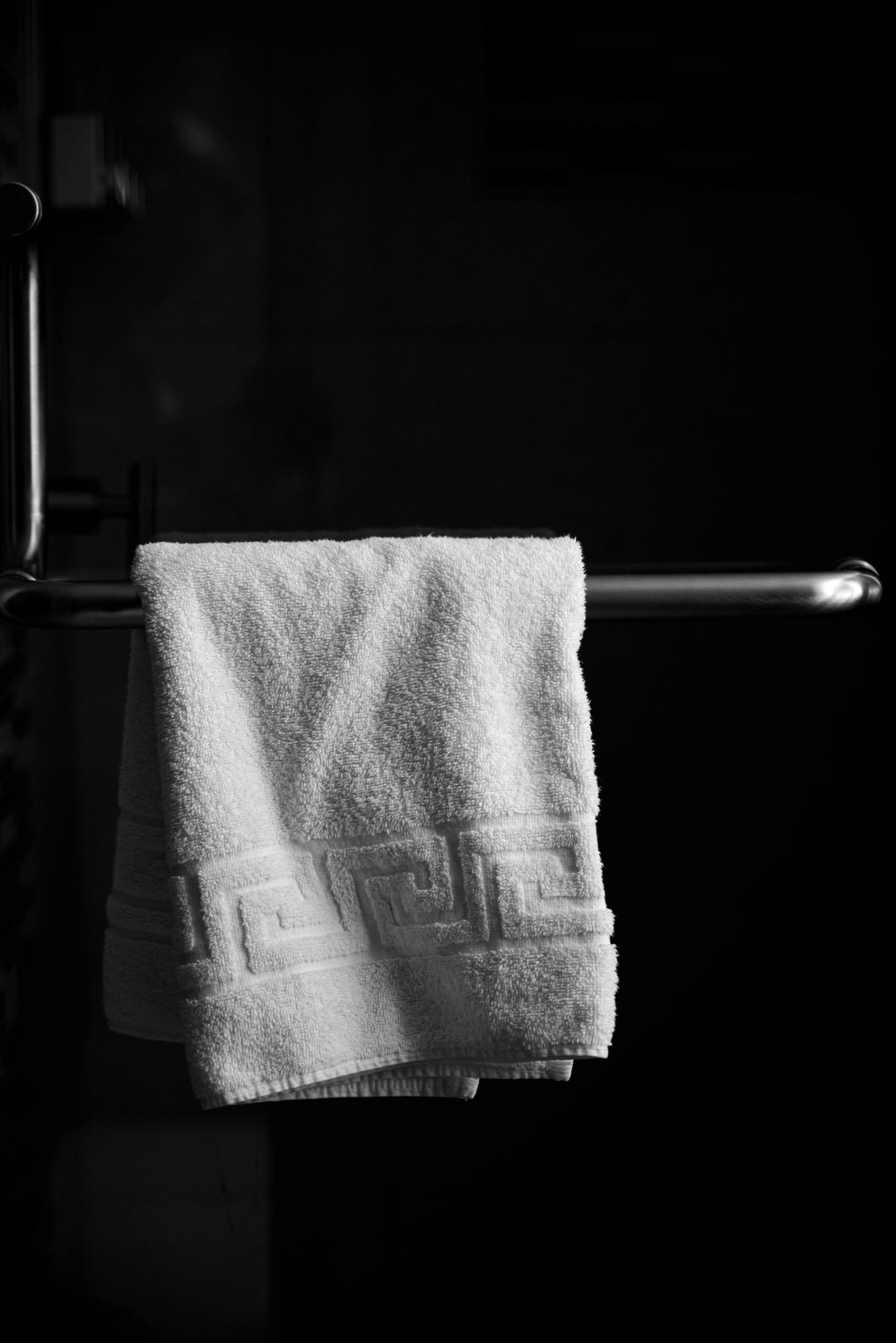 Towel hanging on a rail in black and white