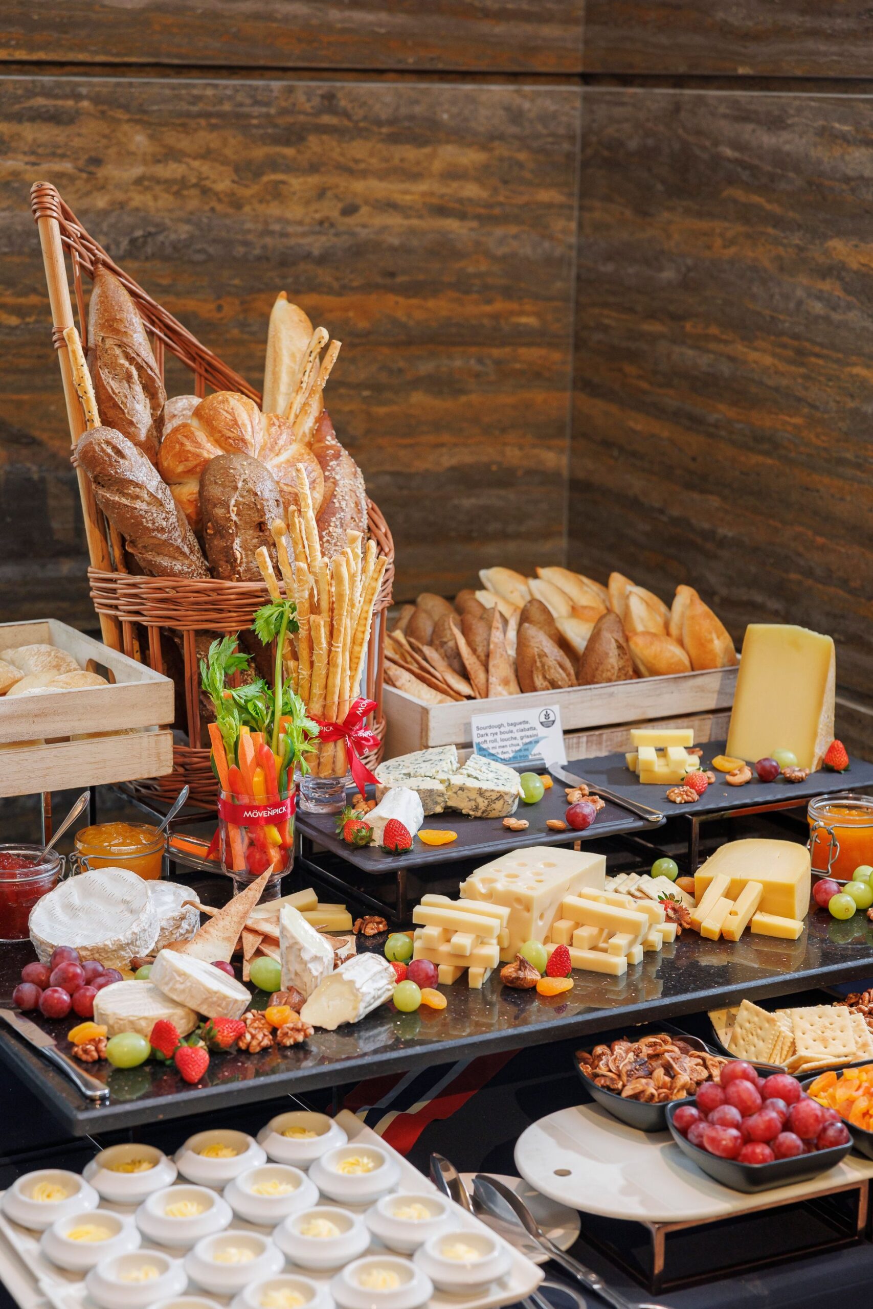 Buffet display with breads, cheeses, grapes, and nuts