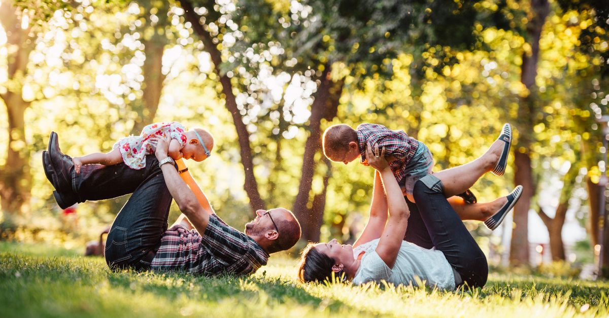 Parents playing with their children in the park