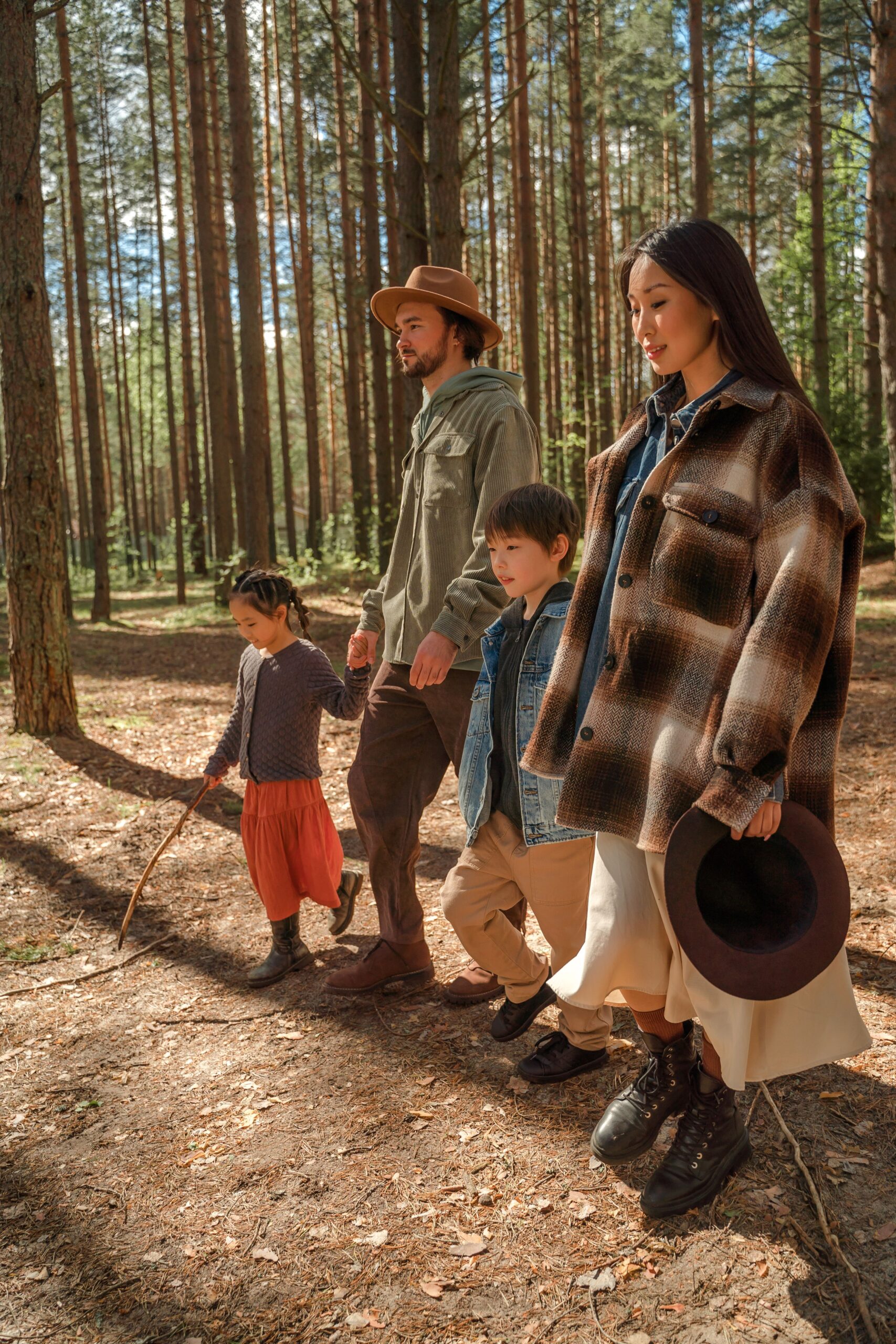 Family walking in the forest holding hands