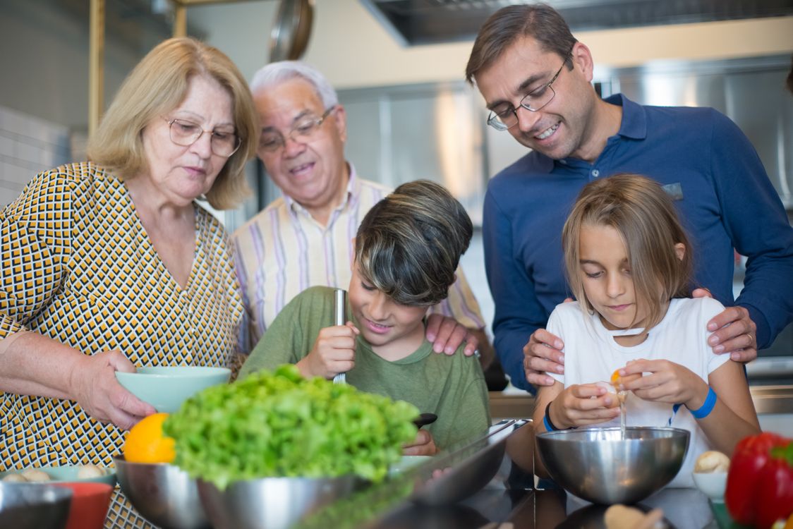 Multi-generational family cooking together in the kitchen
