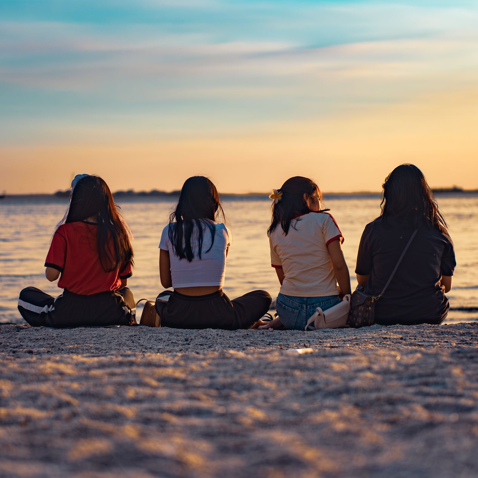 Friends at the beach at sunset