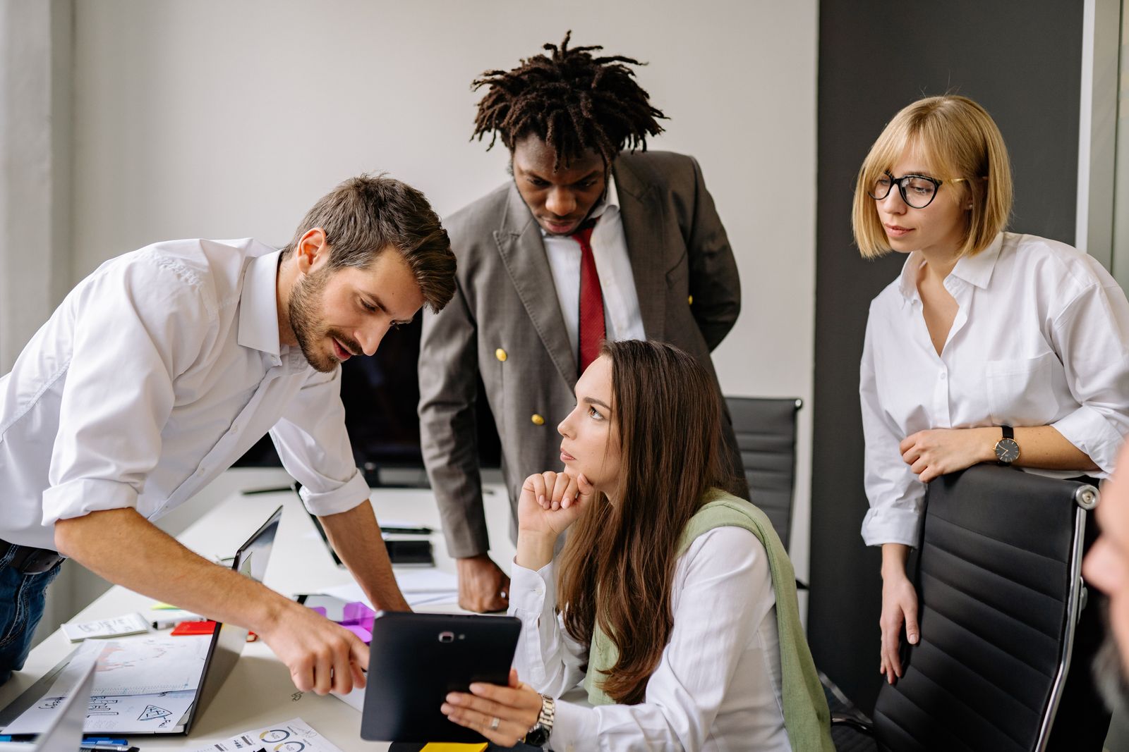 Colleagues working together at a shared desk