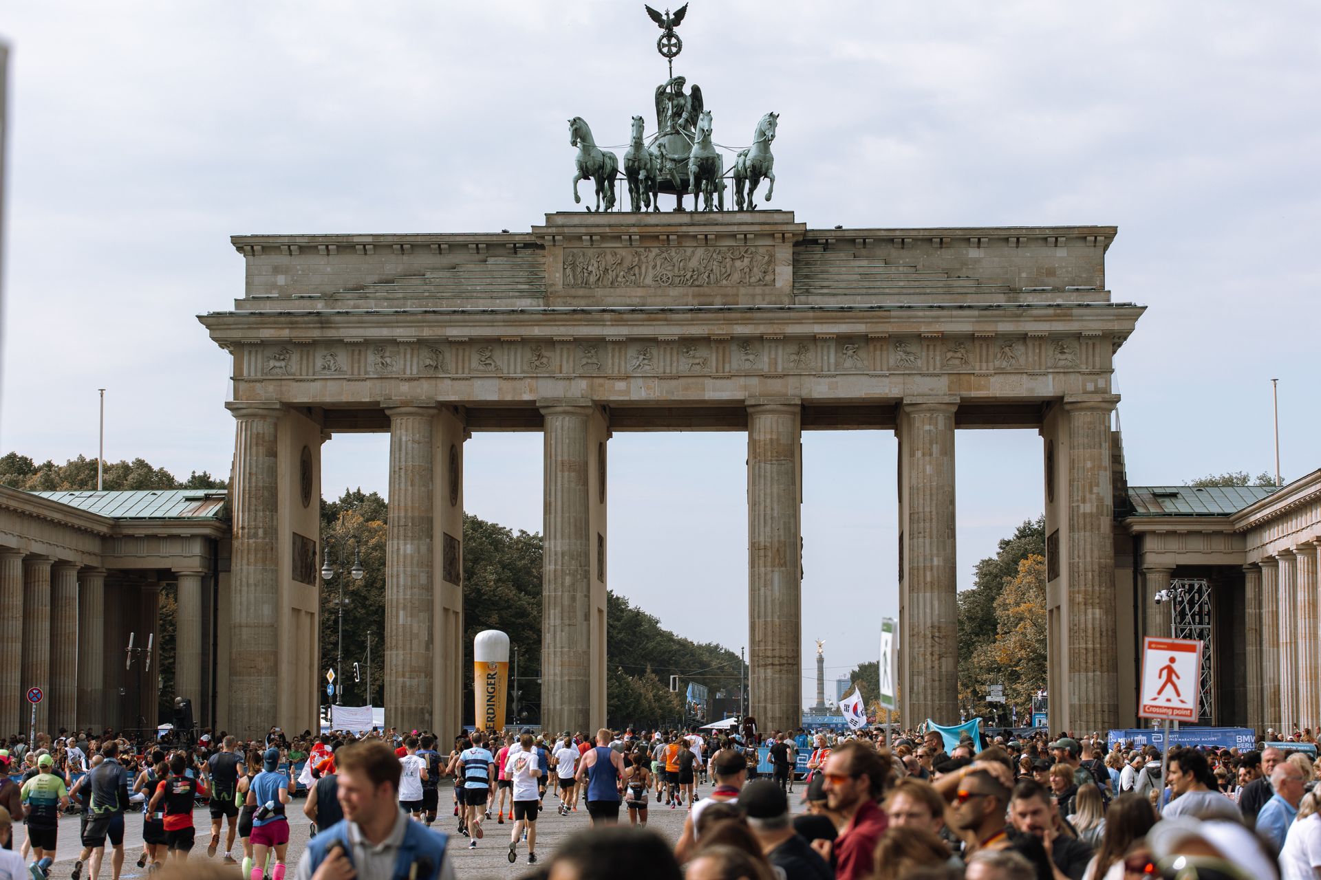 Brandenburg Gate with marathon participants and crowds in Berlin, Germany