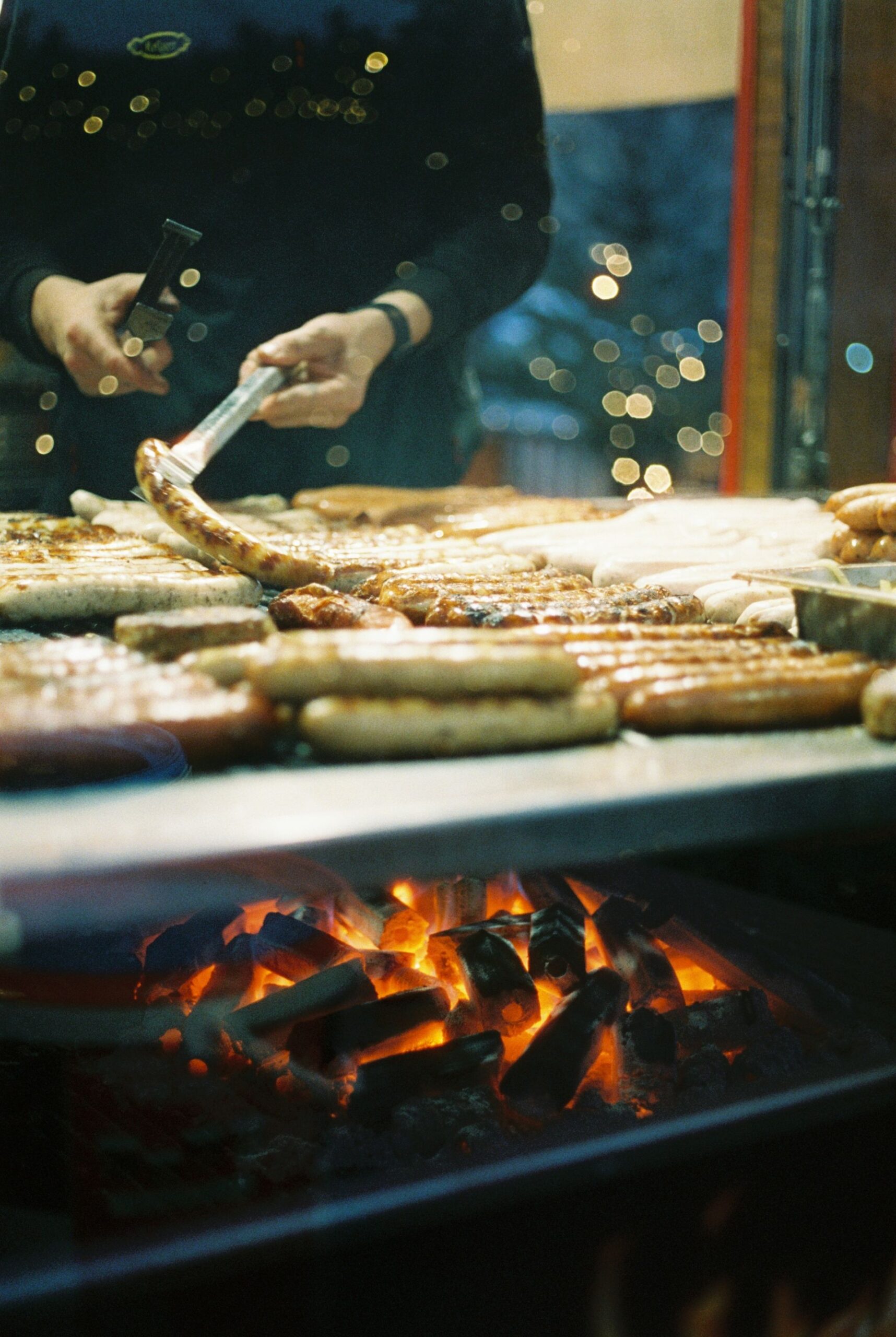 Authentic German sausages grilling over flames at Berlin's winter Christmas market