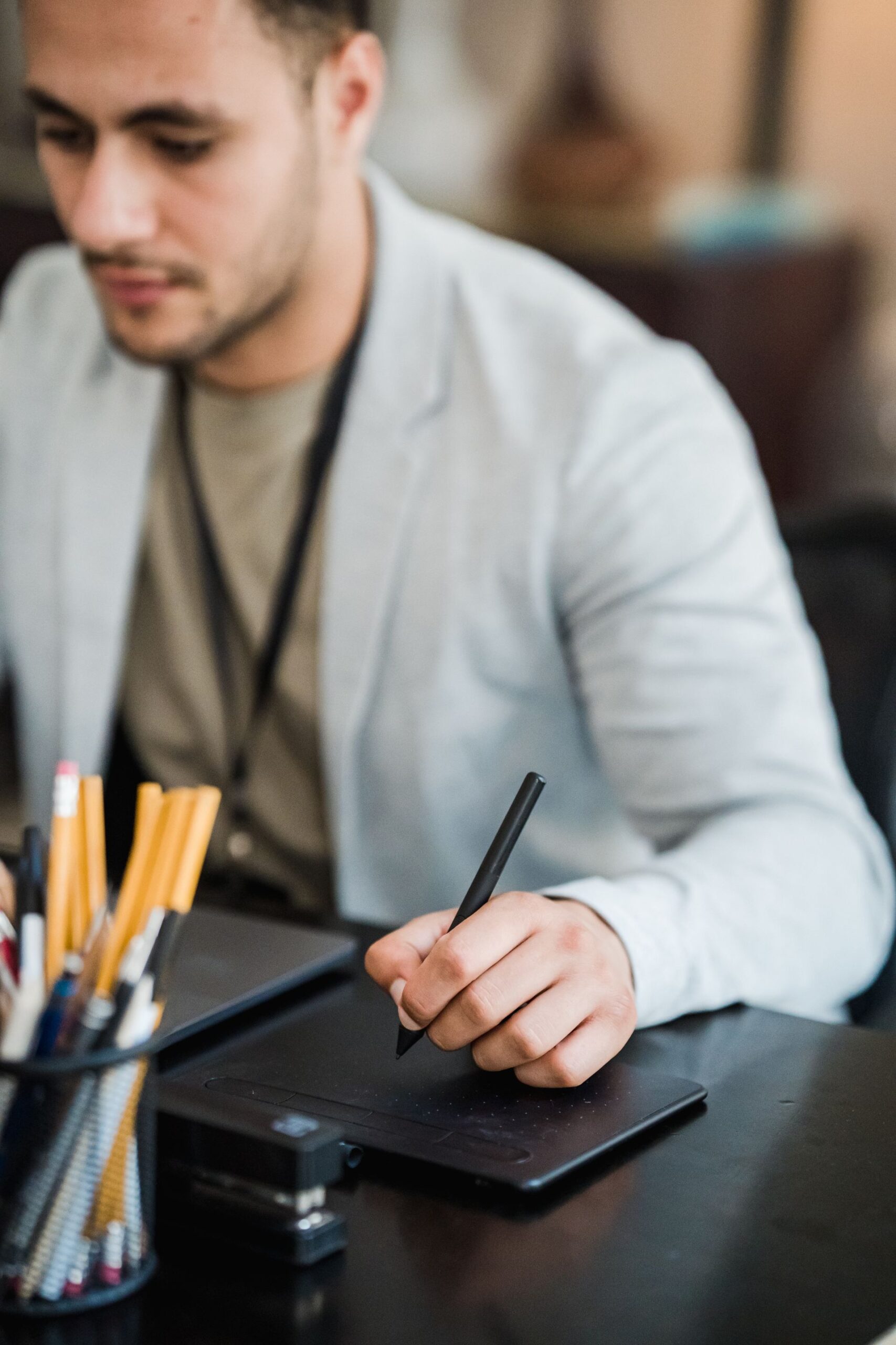 Focused professional working on a tablet at a modern office desk