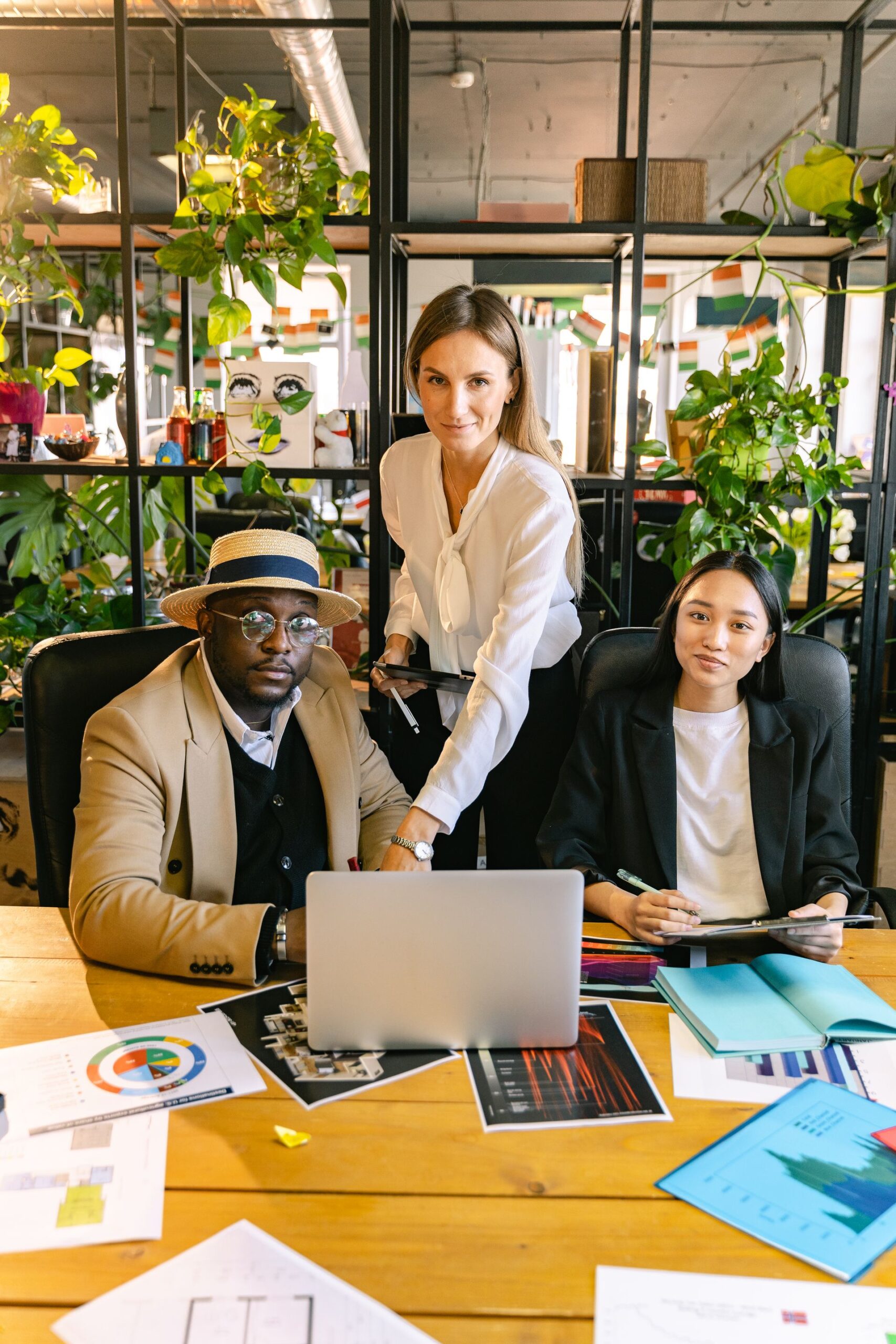 Multicultural team in a business meeting with laptops in a modern office