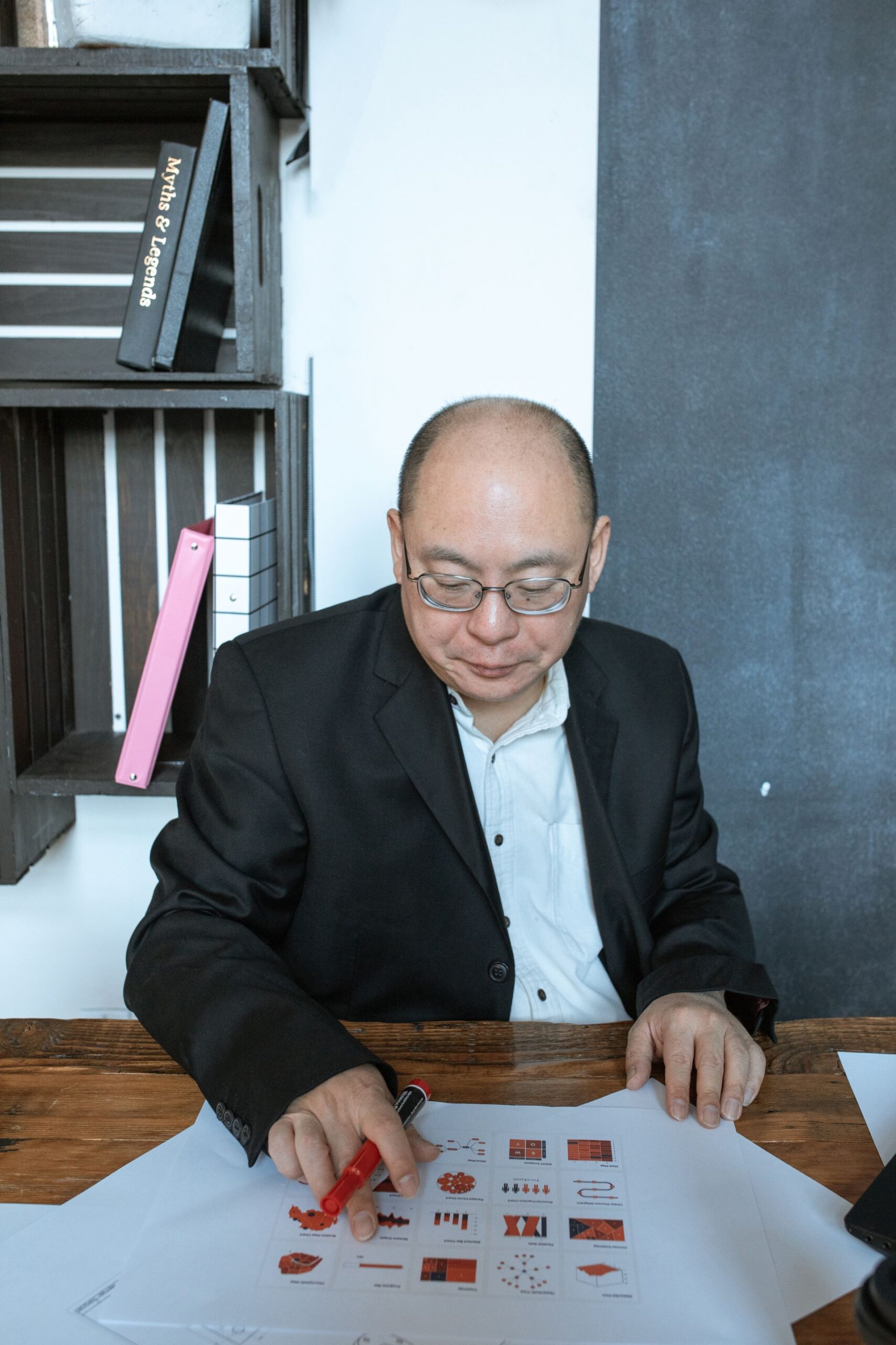 Businessman in a suit reviewing charts at an office desk