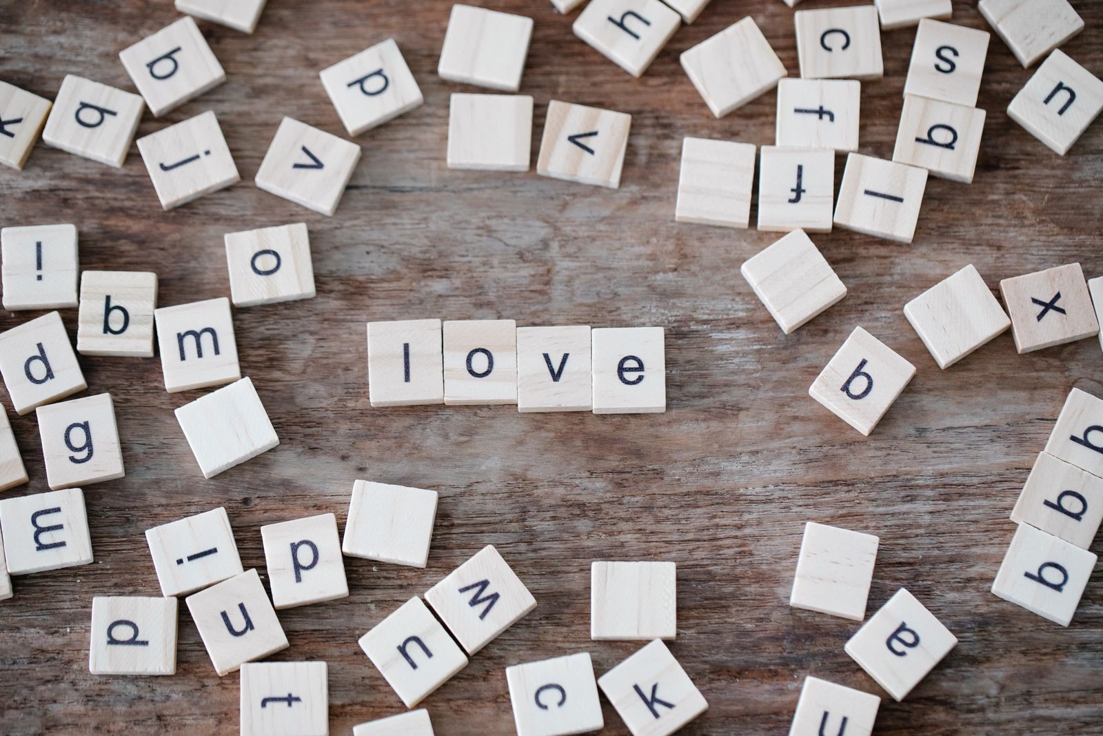 Wooden alphabet tiles arranged on a surface