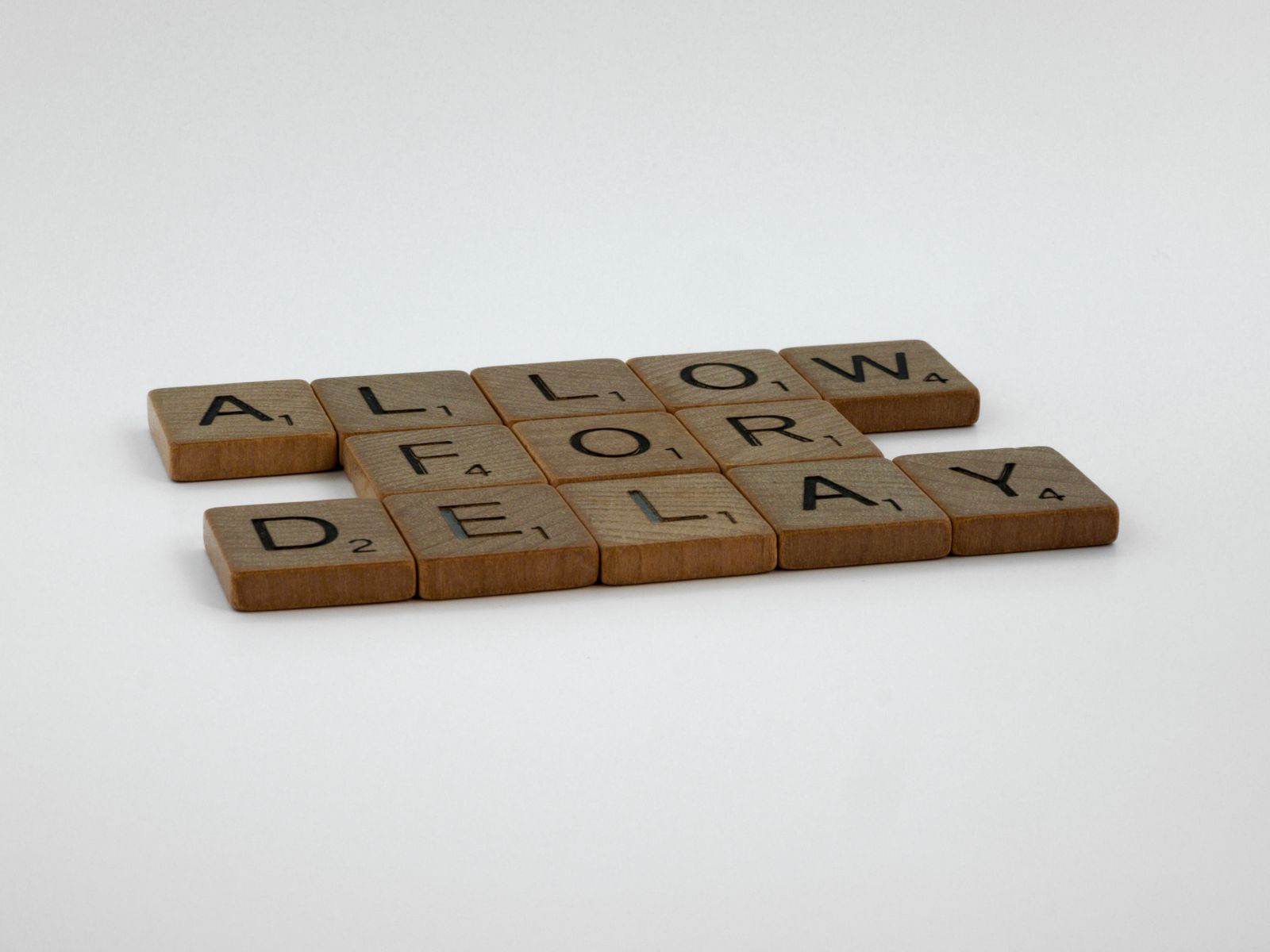 Letter tiles laid out on a wooden table