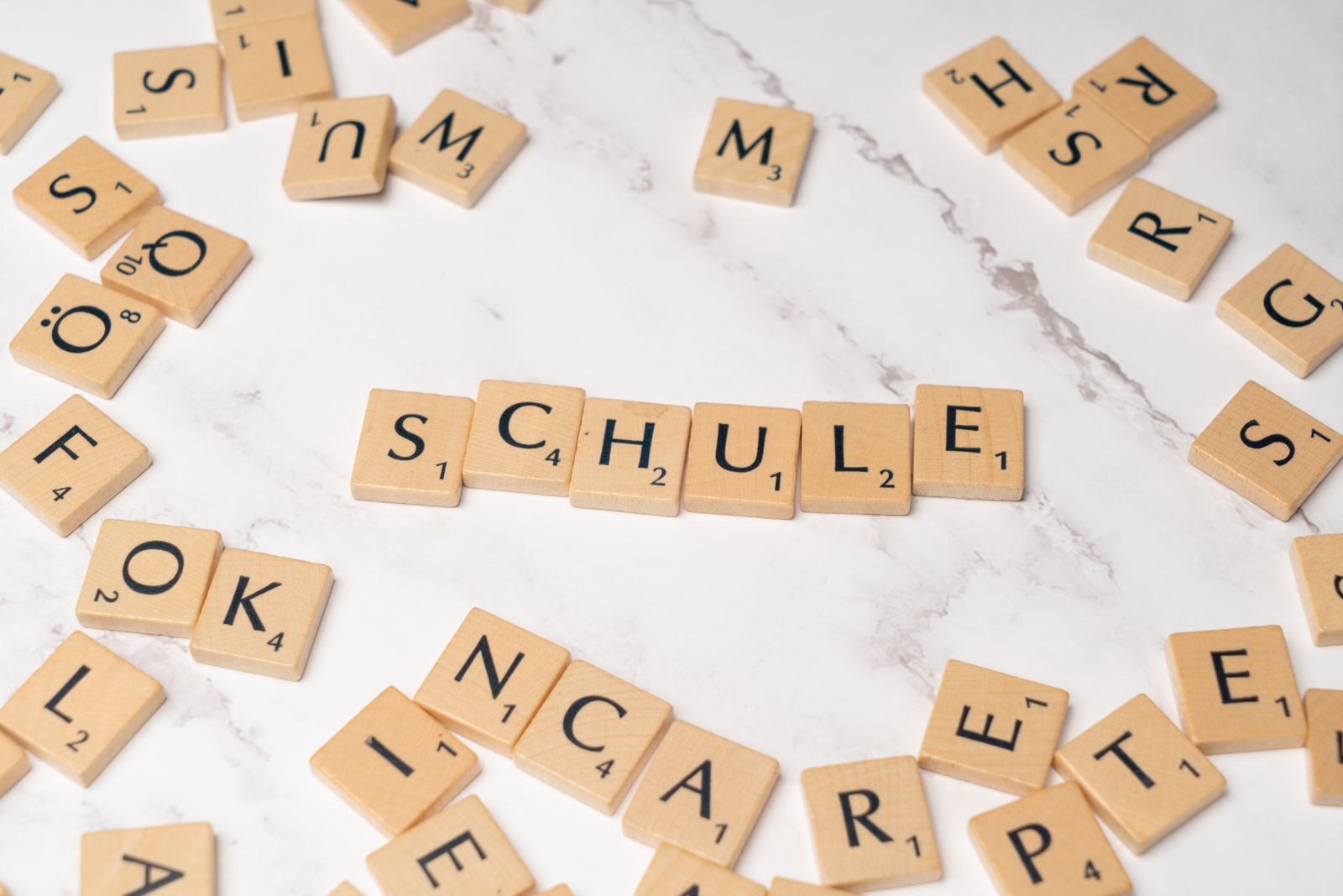 Scrabble tiles spelling Schule, a German word
