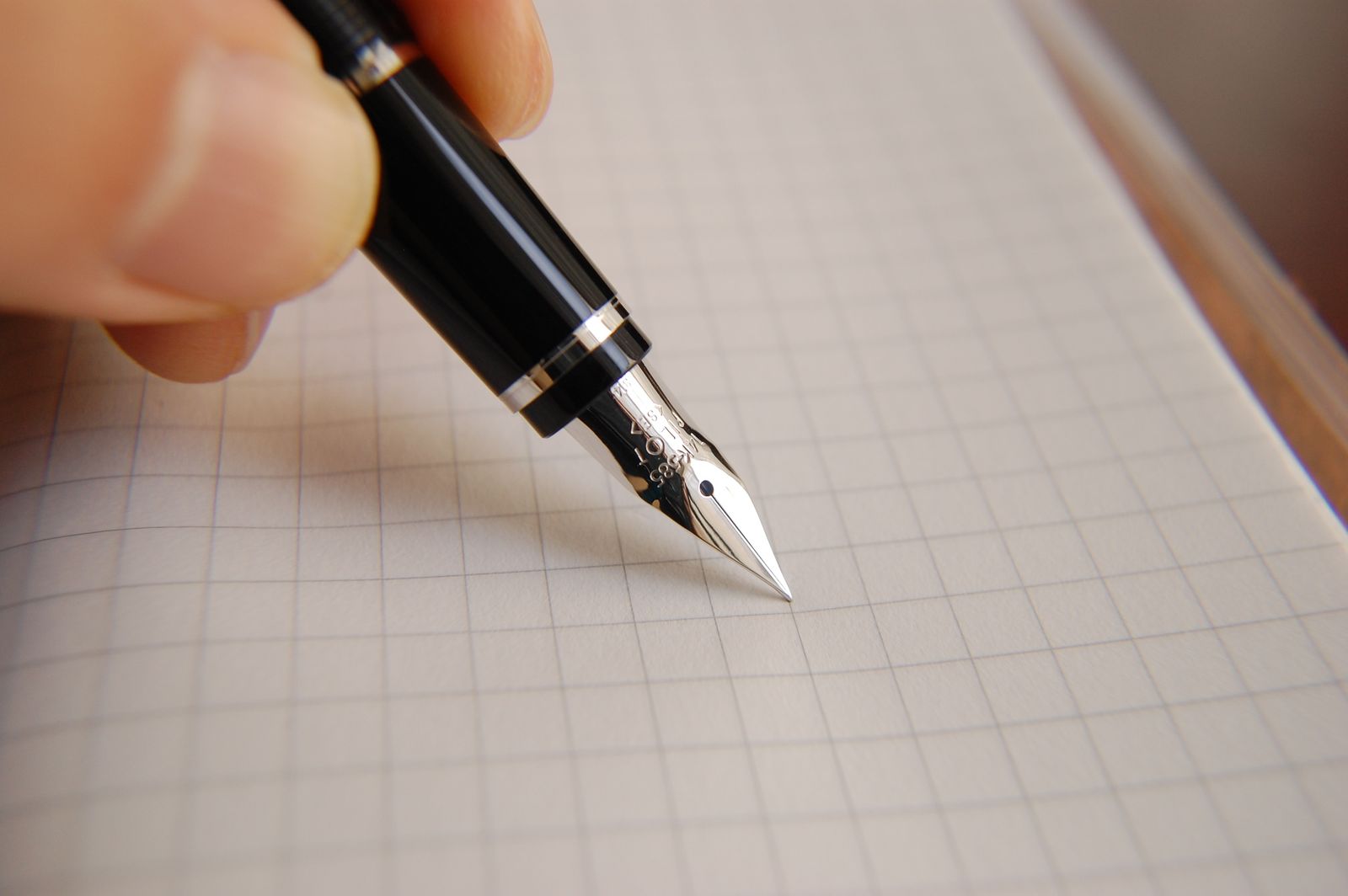 Hand writing with a fountain pen on paper