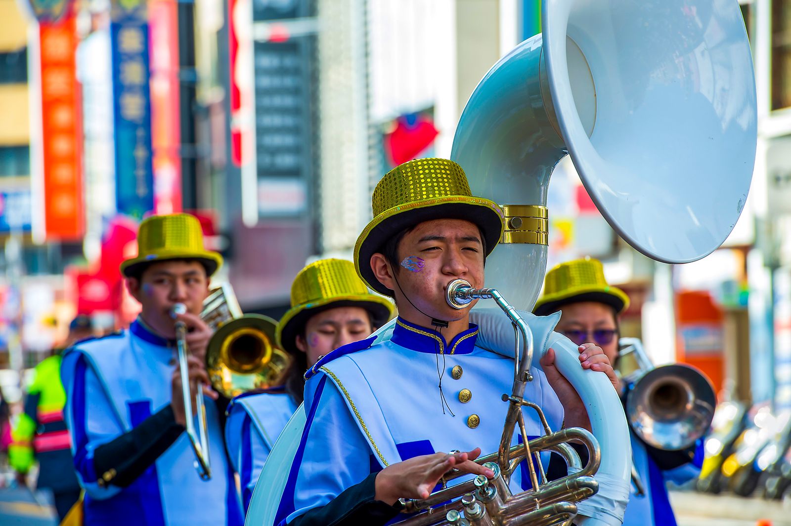 Brass band musicians playing in a colorful street parade
