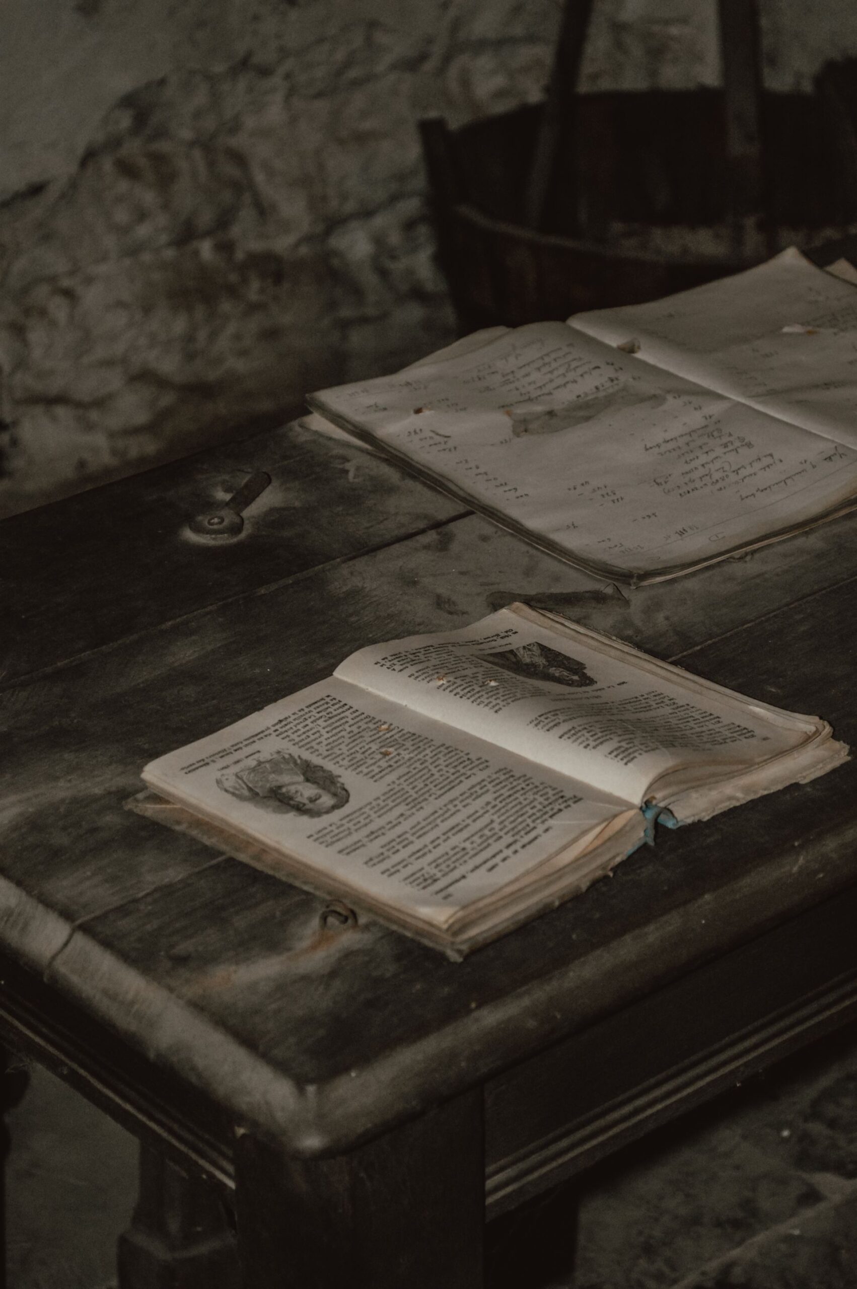 Pile of vintage open books on a rustic wooden table