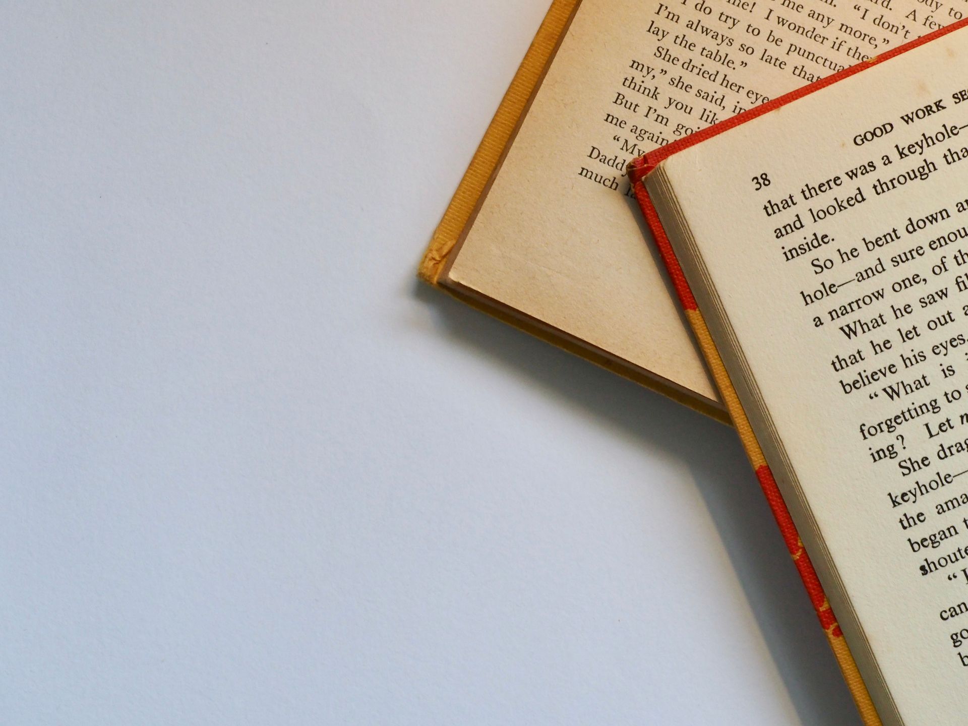 Top view of open books with visible pages and text
