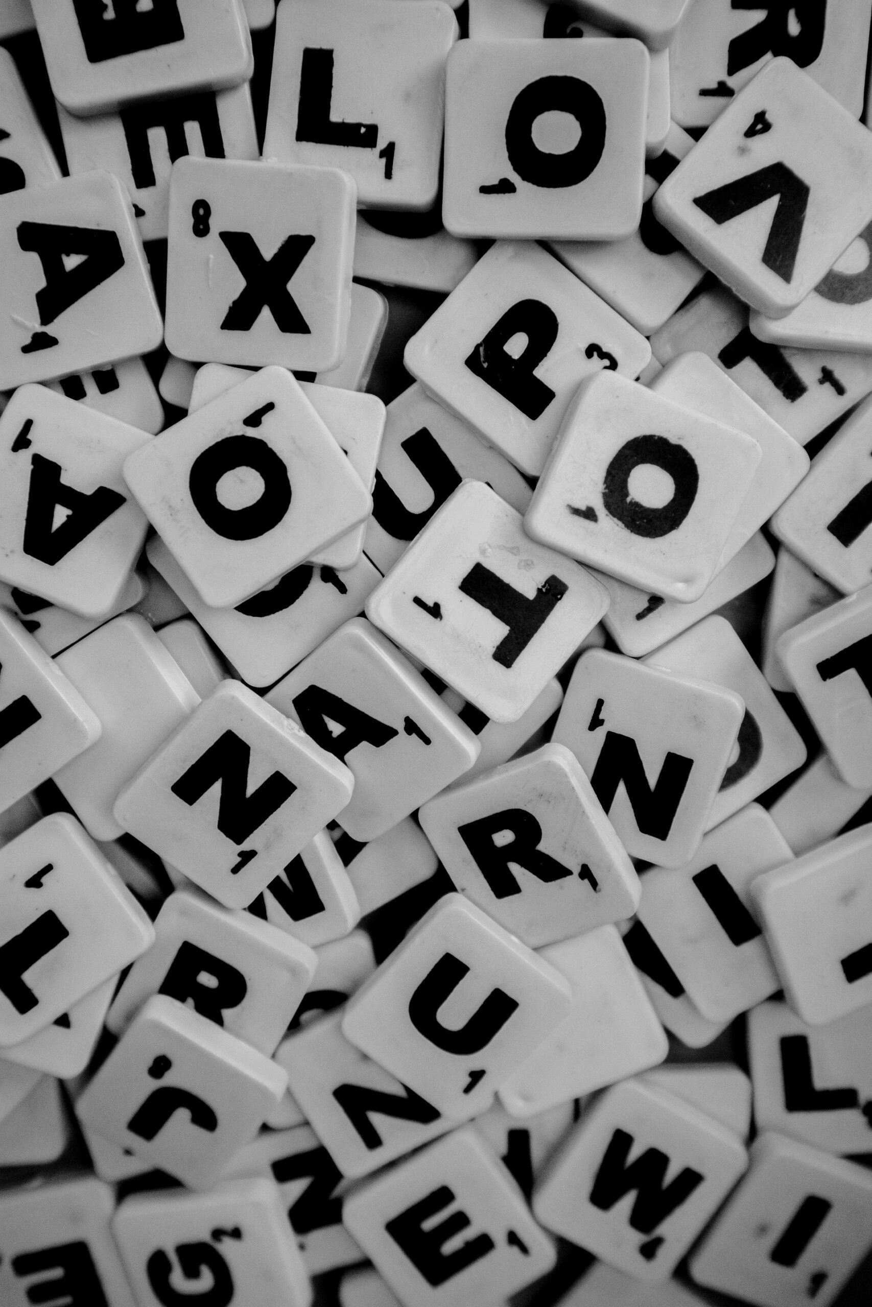 Close-up of a pile of Scrabble tiles showing different letters