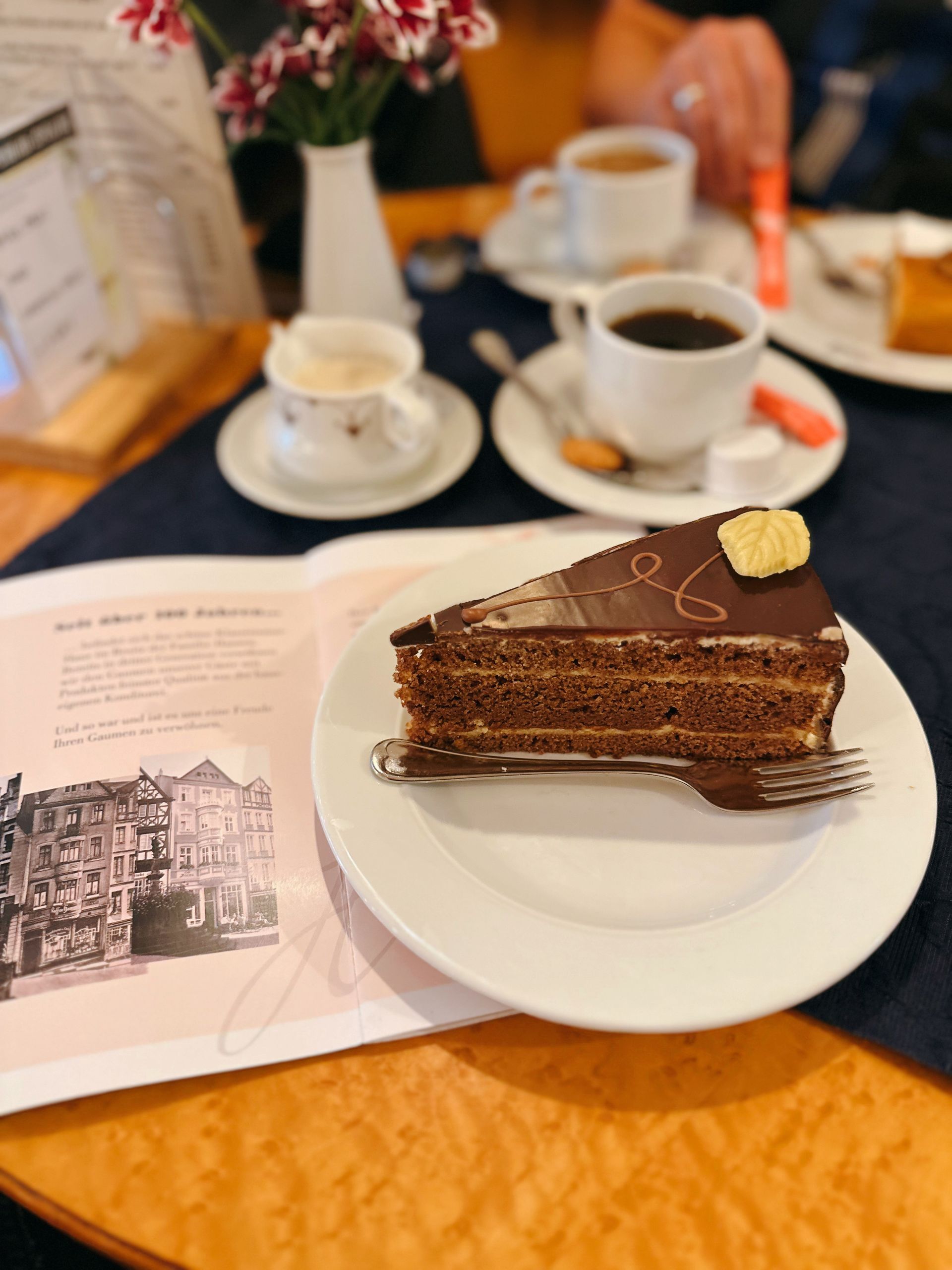 Chocolate cake slice with coffee in a cozy café