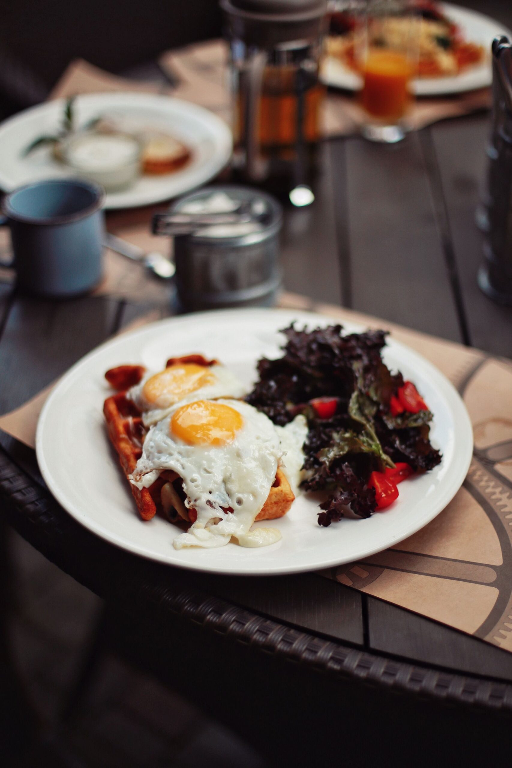 Breakfast plate with sunny-side-up eggs, salad and toast