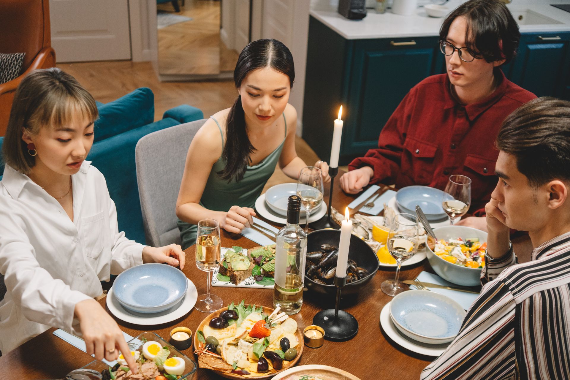 Group of friends dining together around a candle-lit table