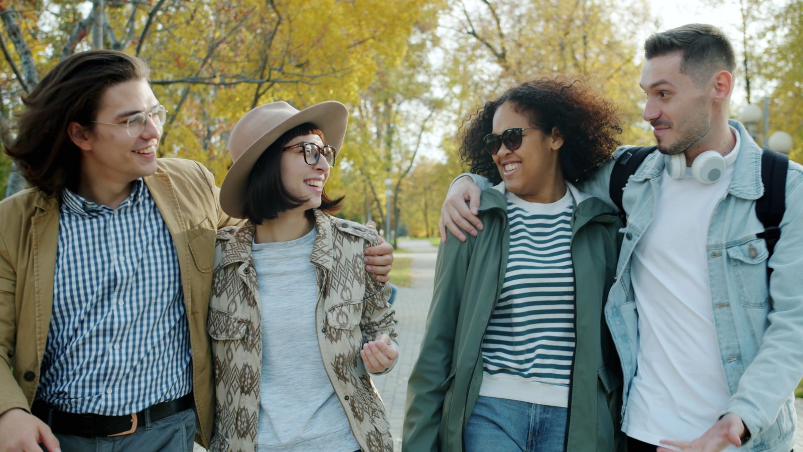 Group of young people walking together in a park
