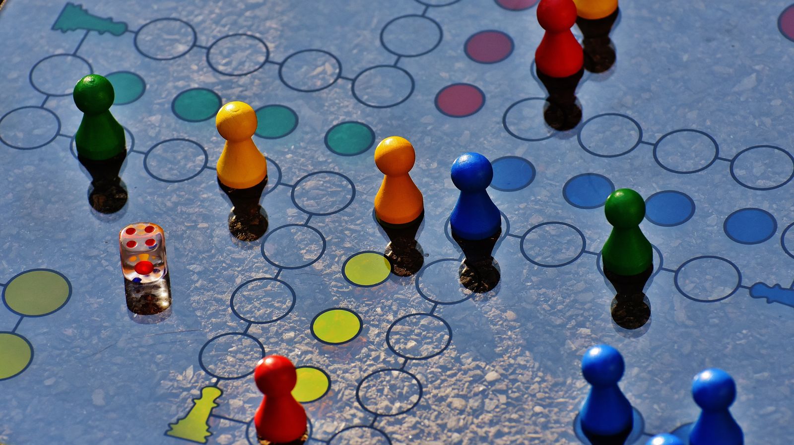 Dice and game pieces on a board