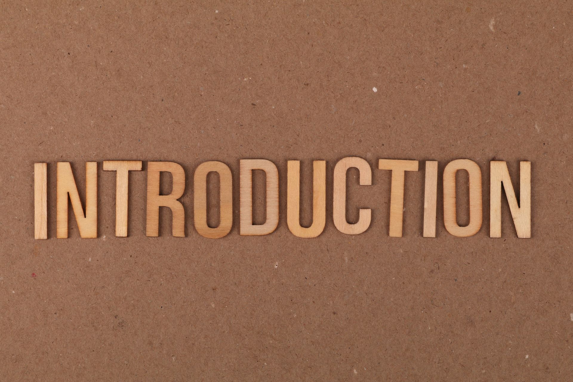 Wooden letters spelling INTRODUCTION on cardboard