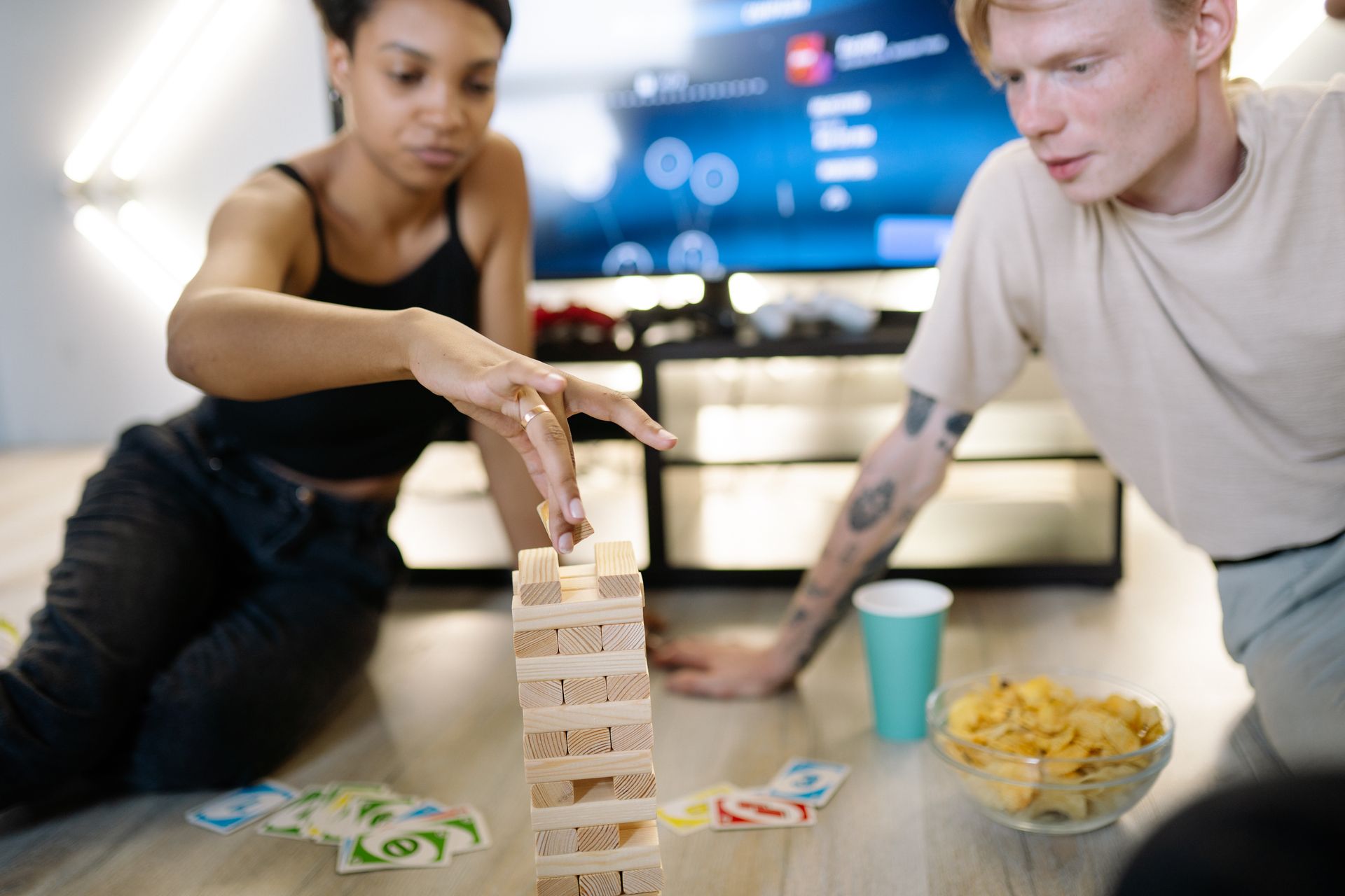 Two friends having fun at a game night with snacks