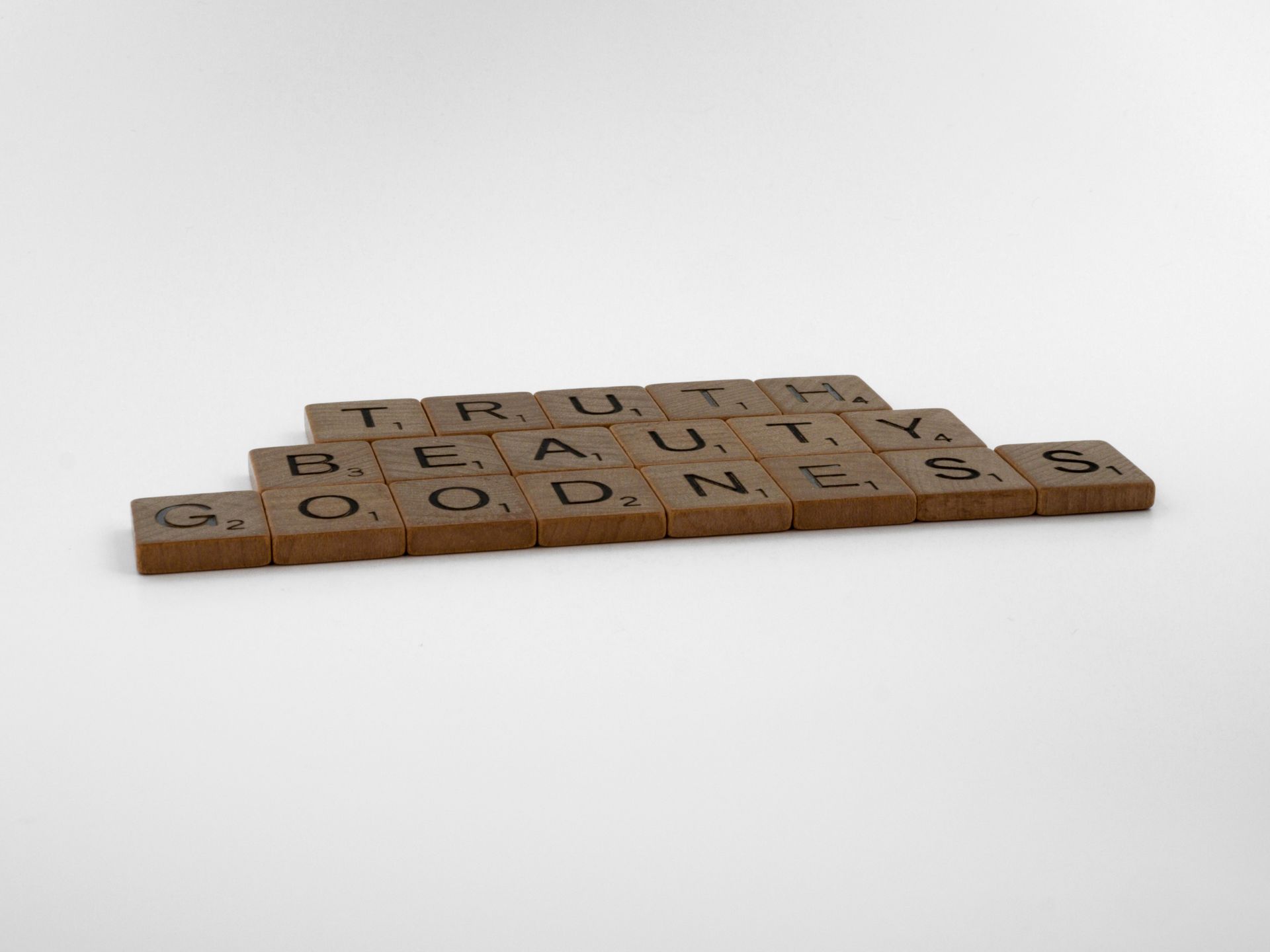 Wooden Scrabble tiles spelling Truth Beauty and Goodness