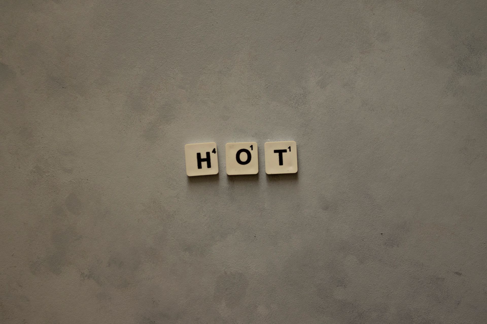 Scrabble tiles spelling a short word on a gray surface