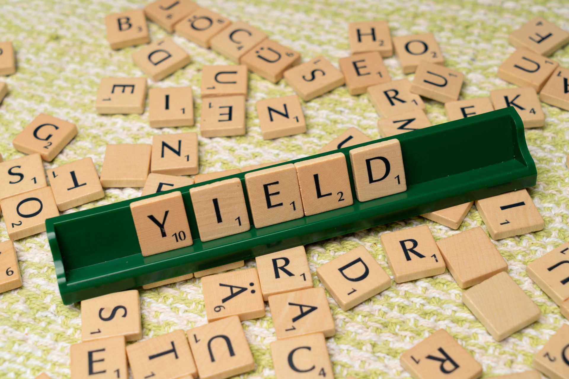 Scrabble board with tiles played and letters on a rack