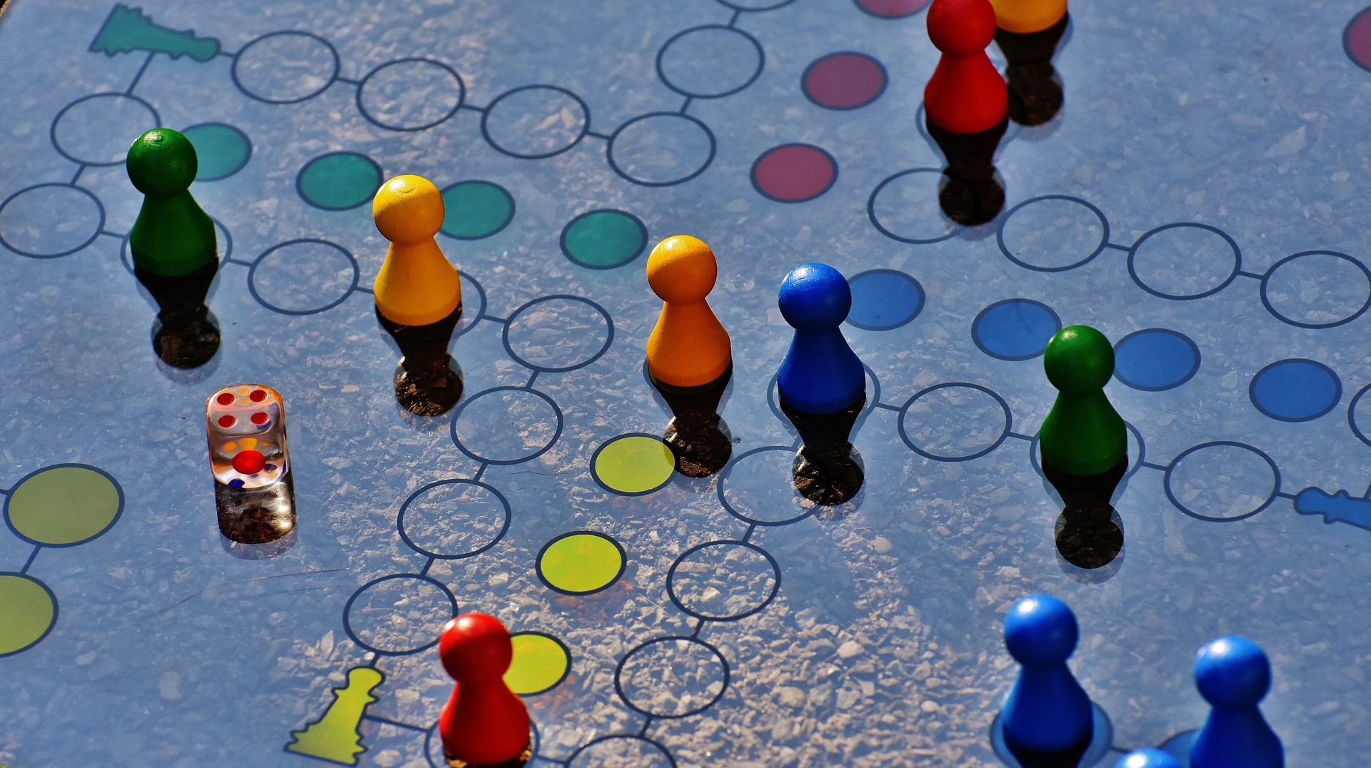 Colorful board game with pawns and dice
