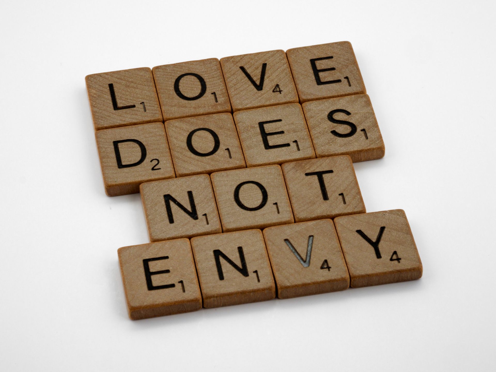 Scrabble tiles spelling a phrase on white