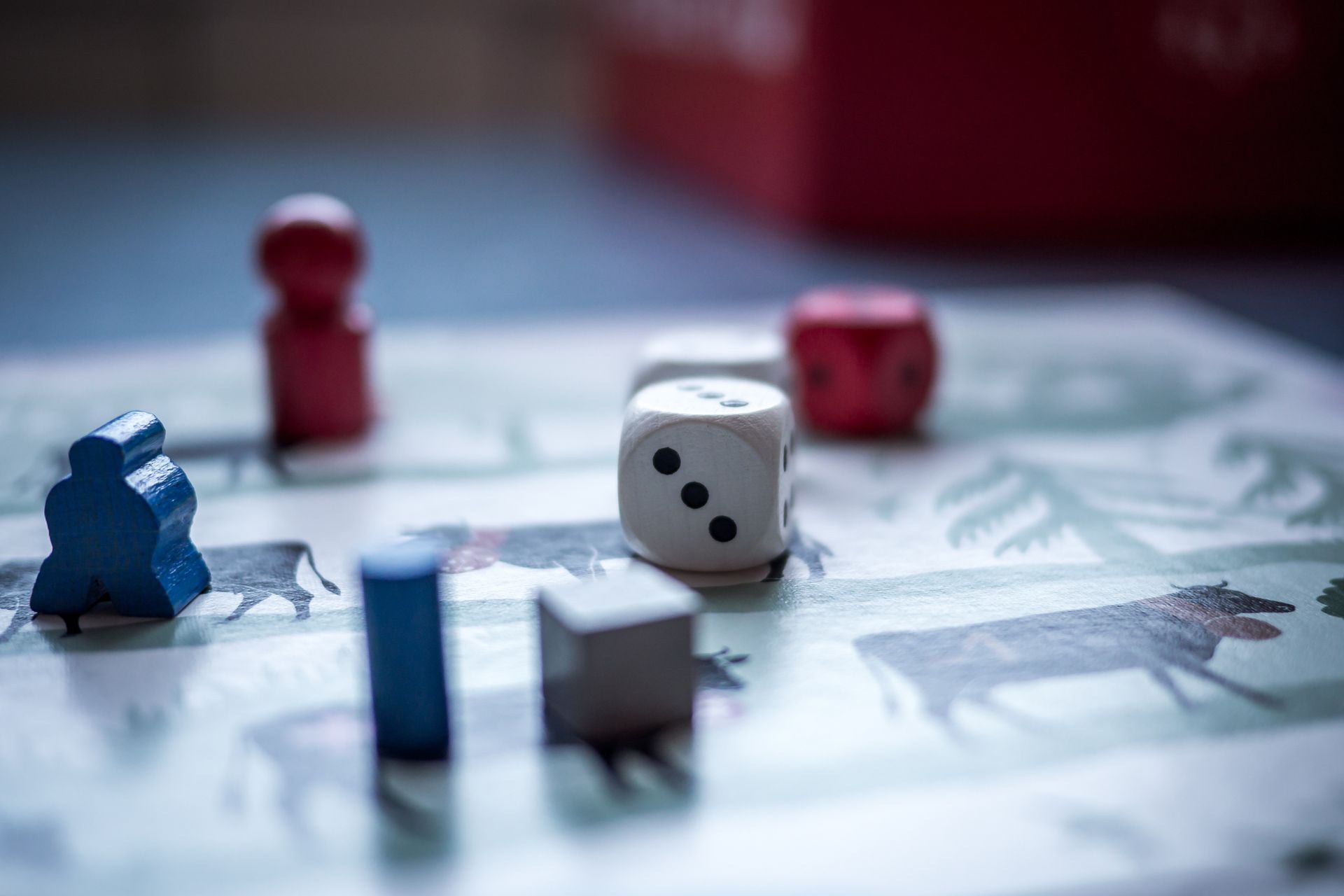 Dice and wooden pieces on a board game