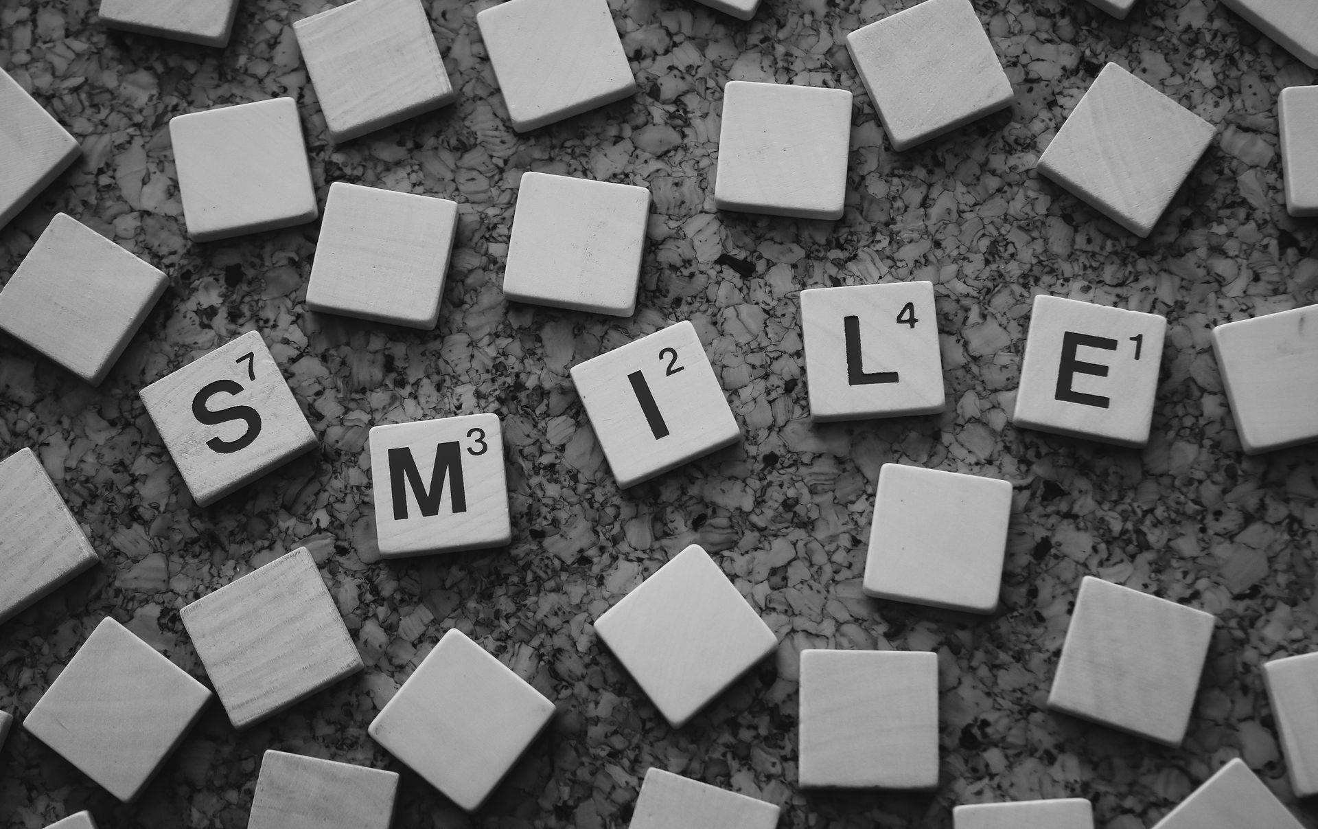 Black and white Scrabble tiles spelling a word
