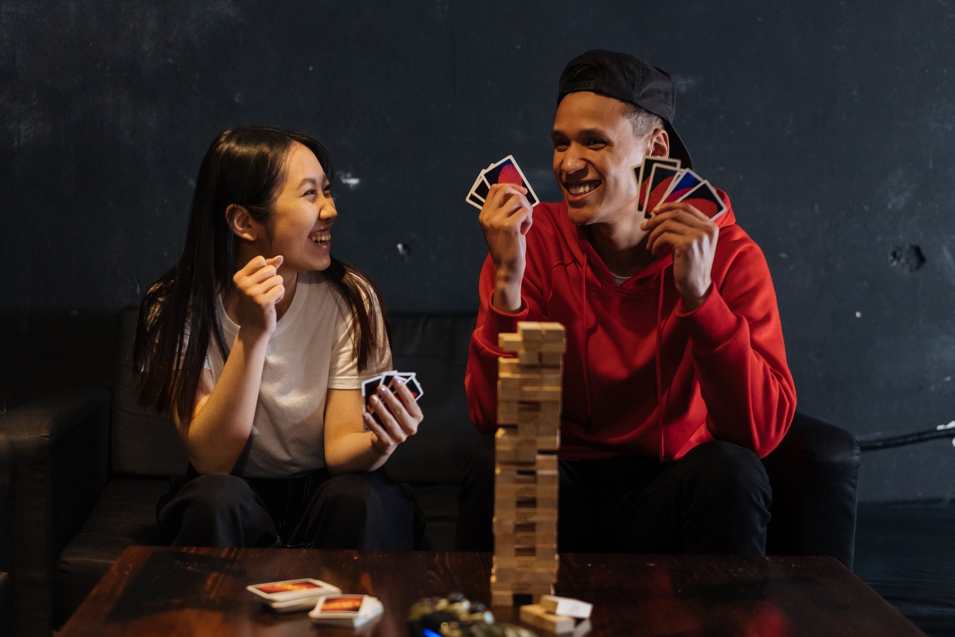 Friends laughing during a game night indoors