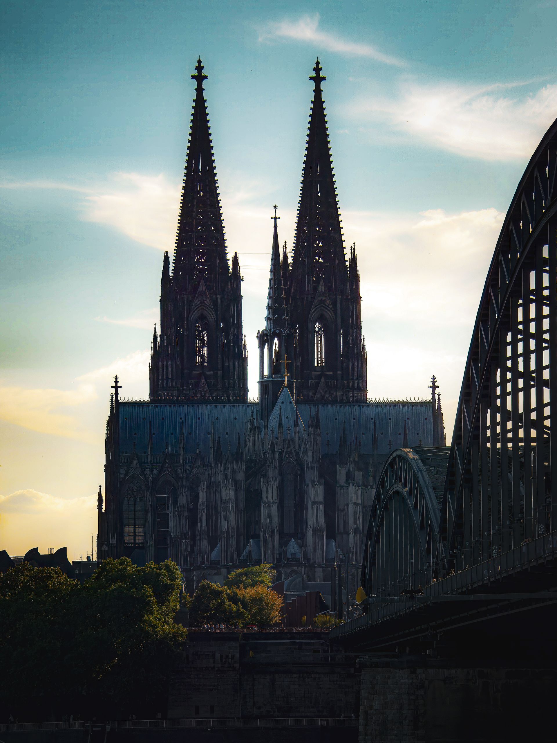 Cologne Cathedral beside the Hohenzollern Bridge at sunset