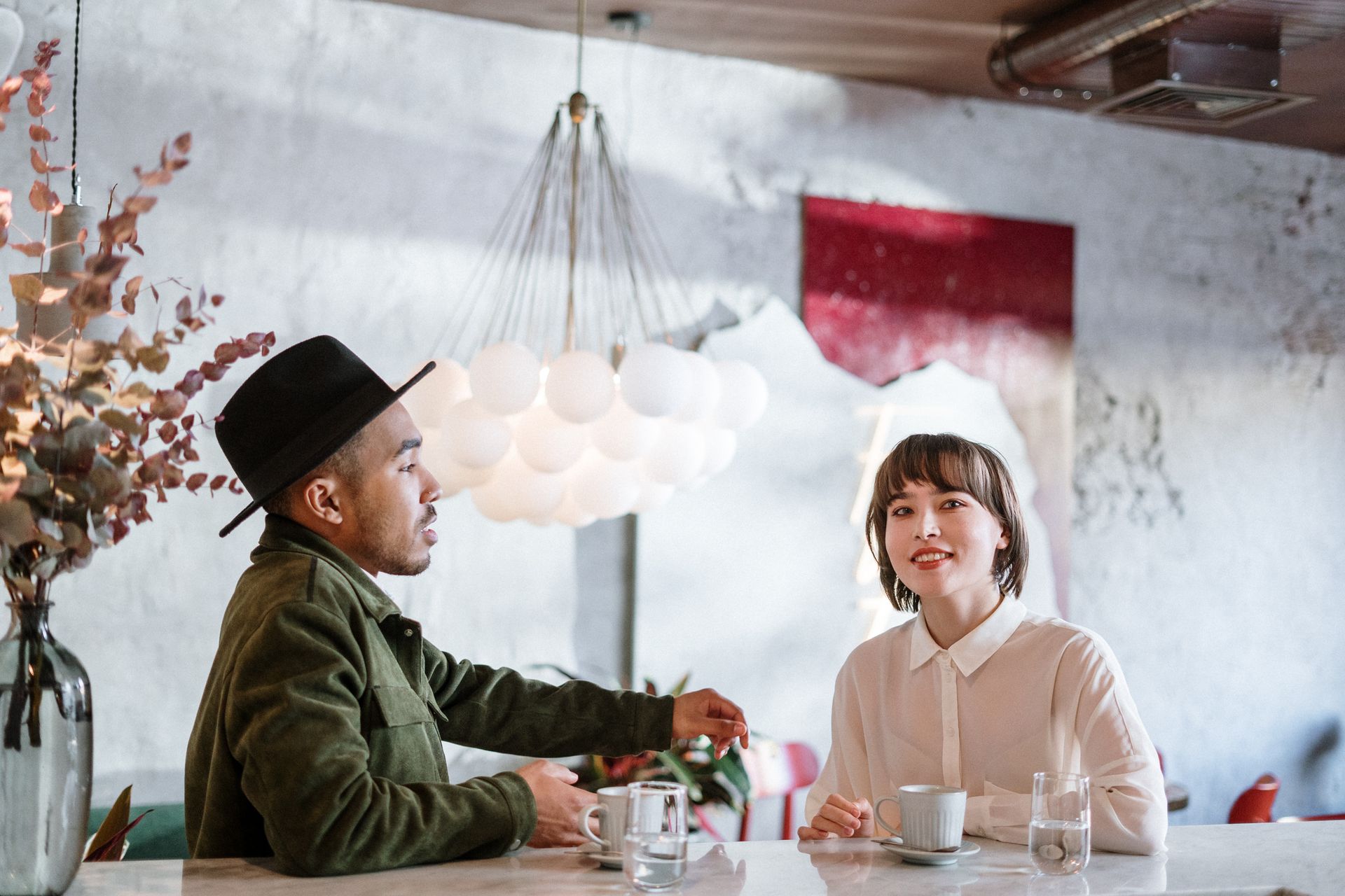 Couple chatting in a stylish café with warm lighting