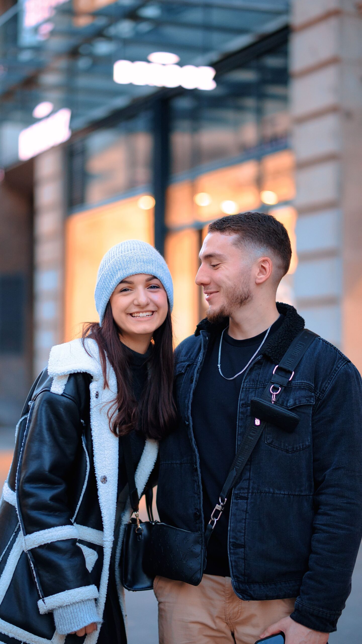 Smiling couple in winter clothing on an urban street