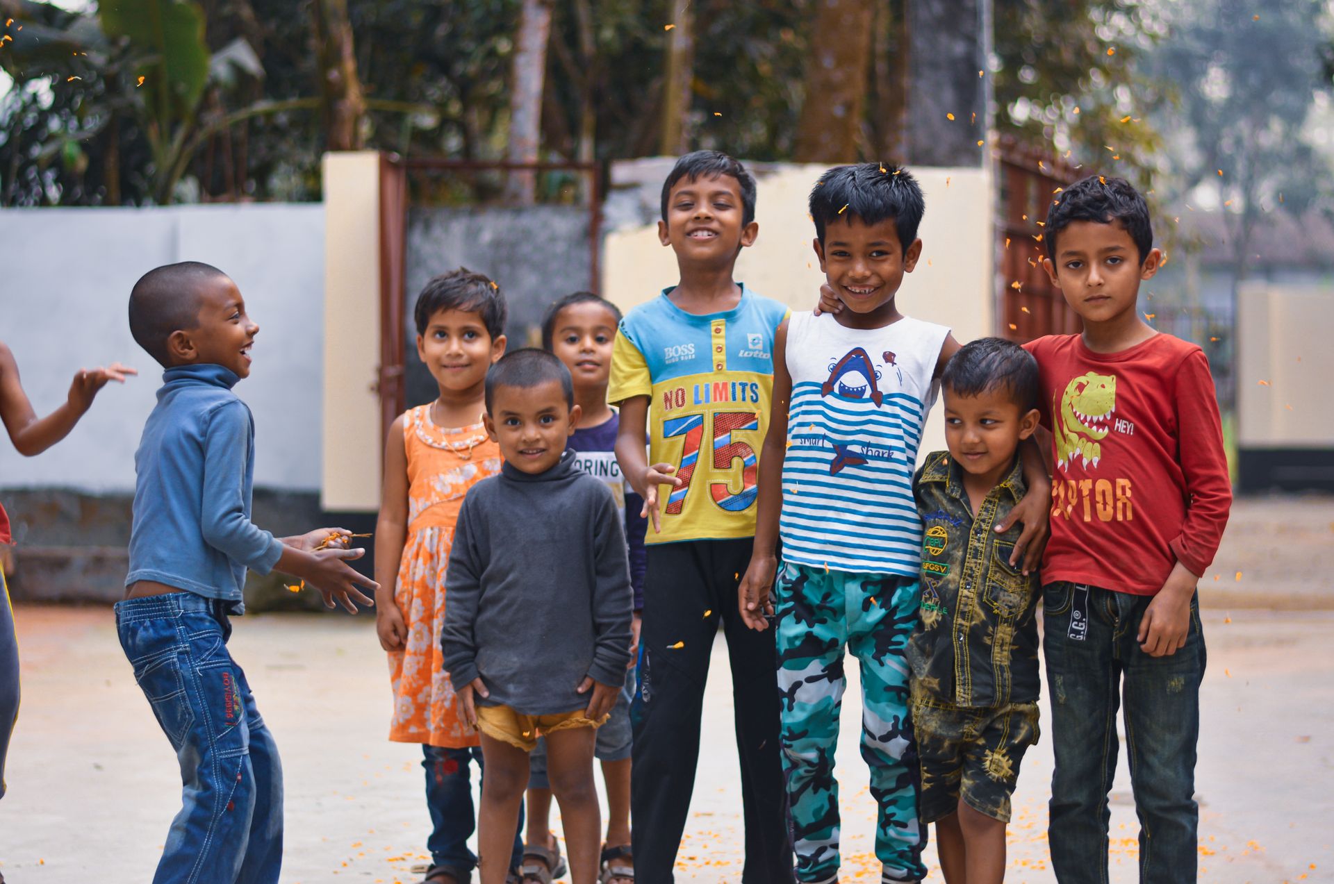 A group of smiling children enjoying playing outdoors, exuding joy and friendship.