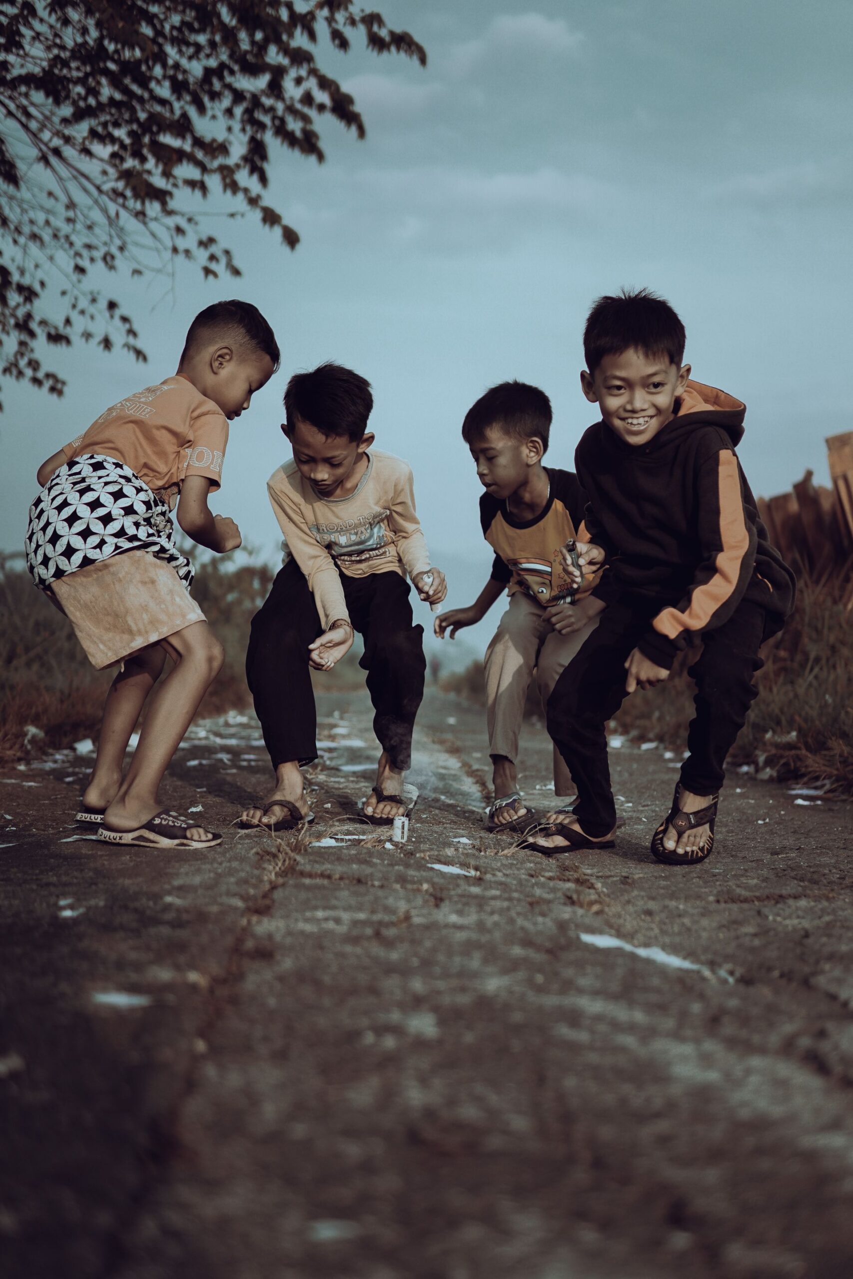 A group of happy children playing together outdoors, showcasing joy and friendship.