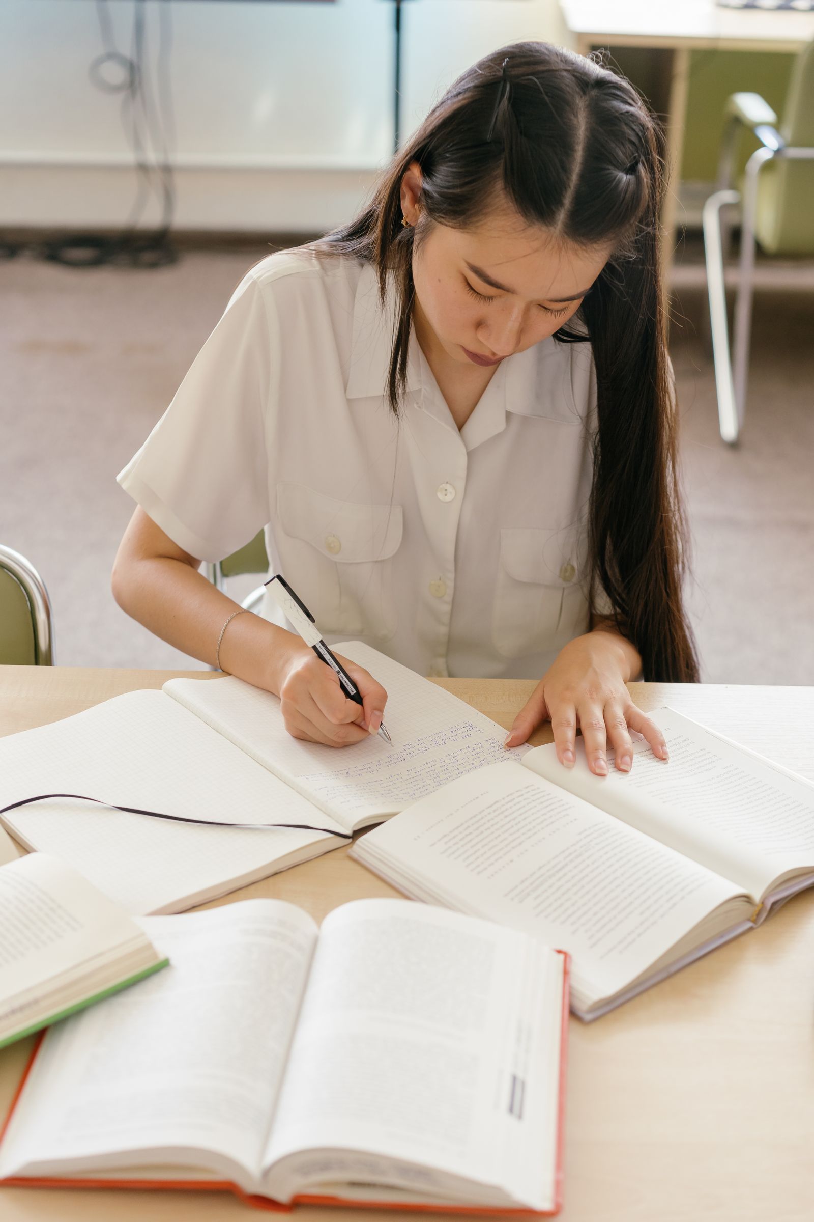 Language learner writing grammar exercises in a notebook