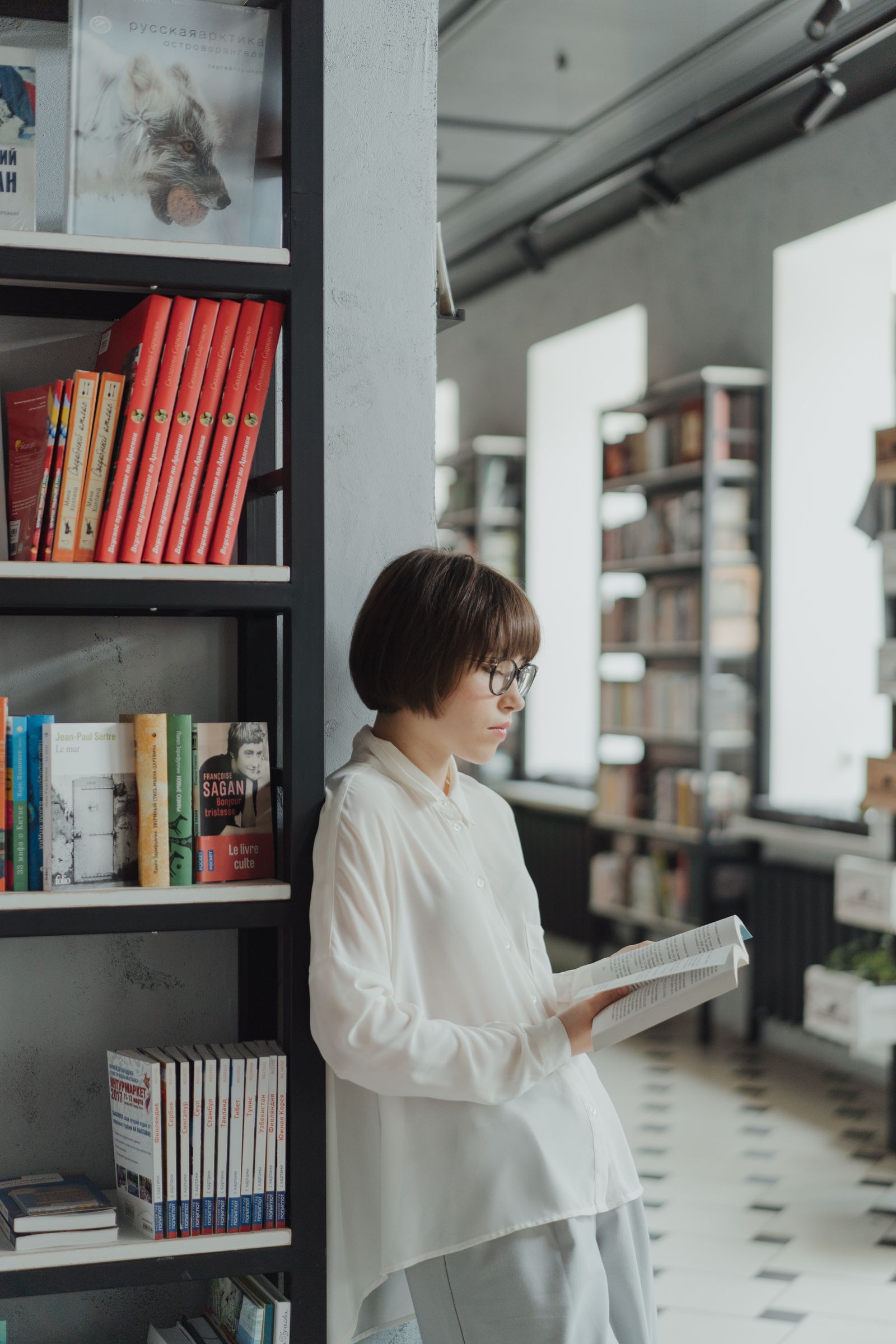 Woman reading in a bright modern library