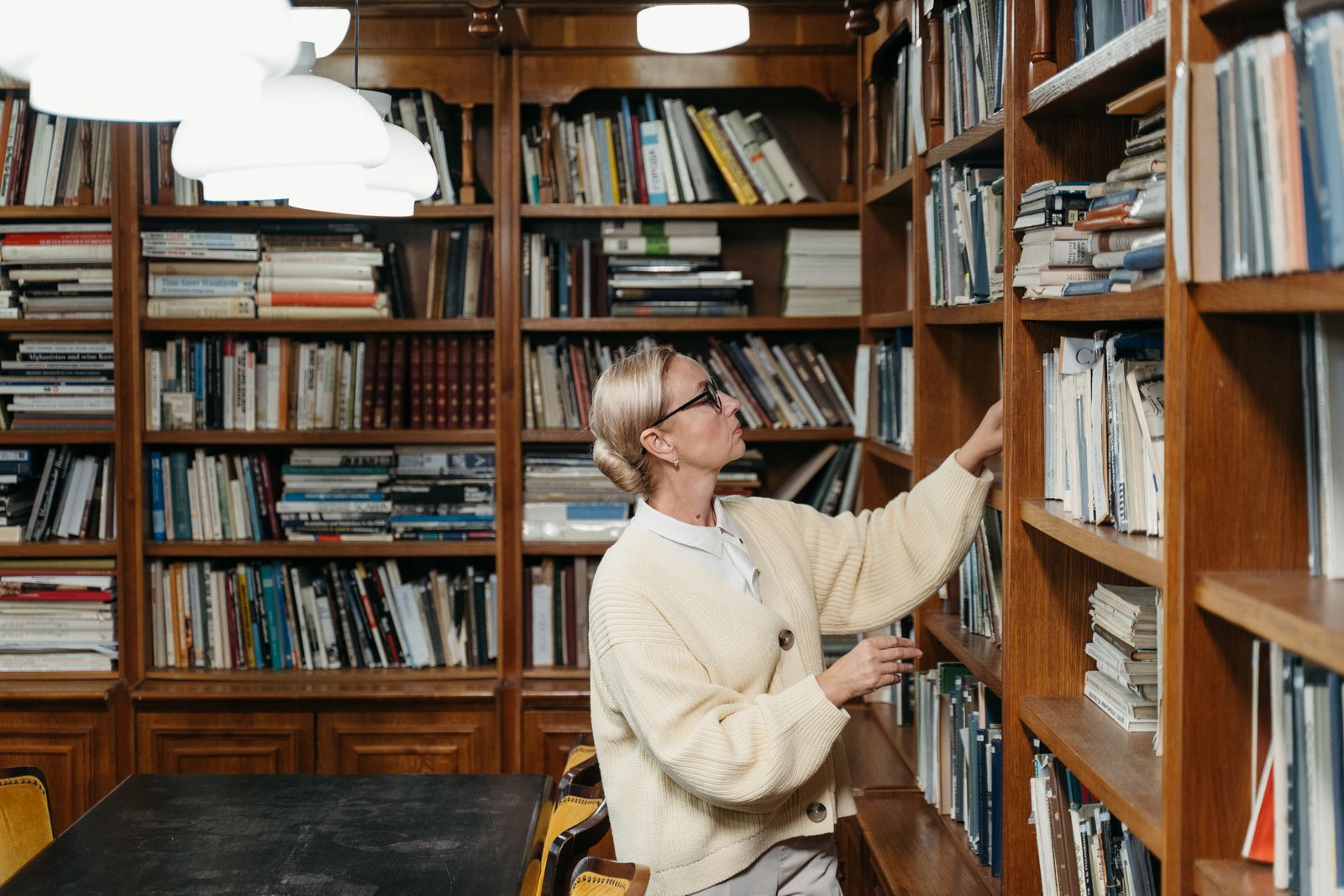Student reading textbooks in a library