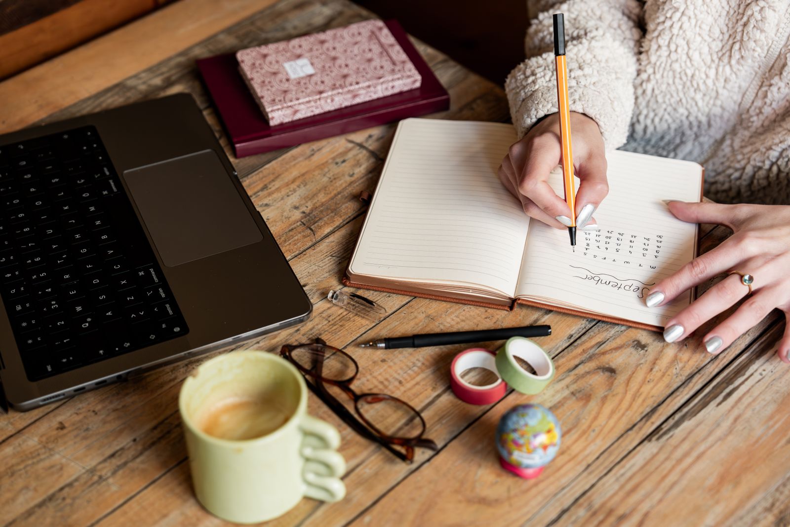 Writer working in a notebook at home