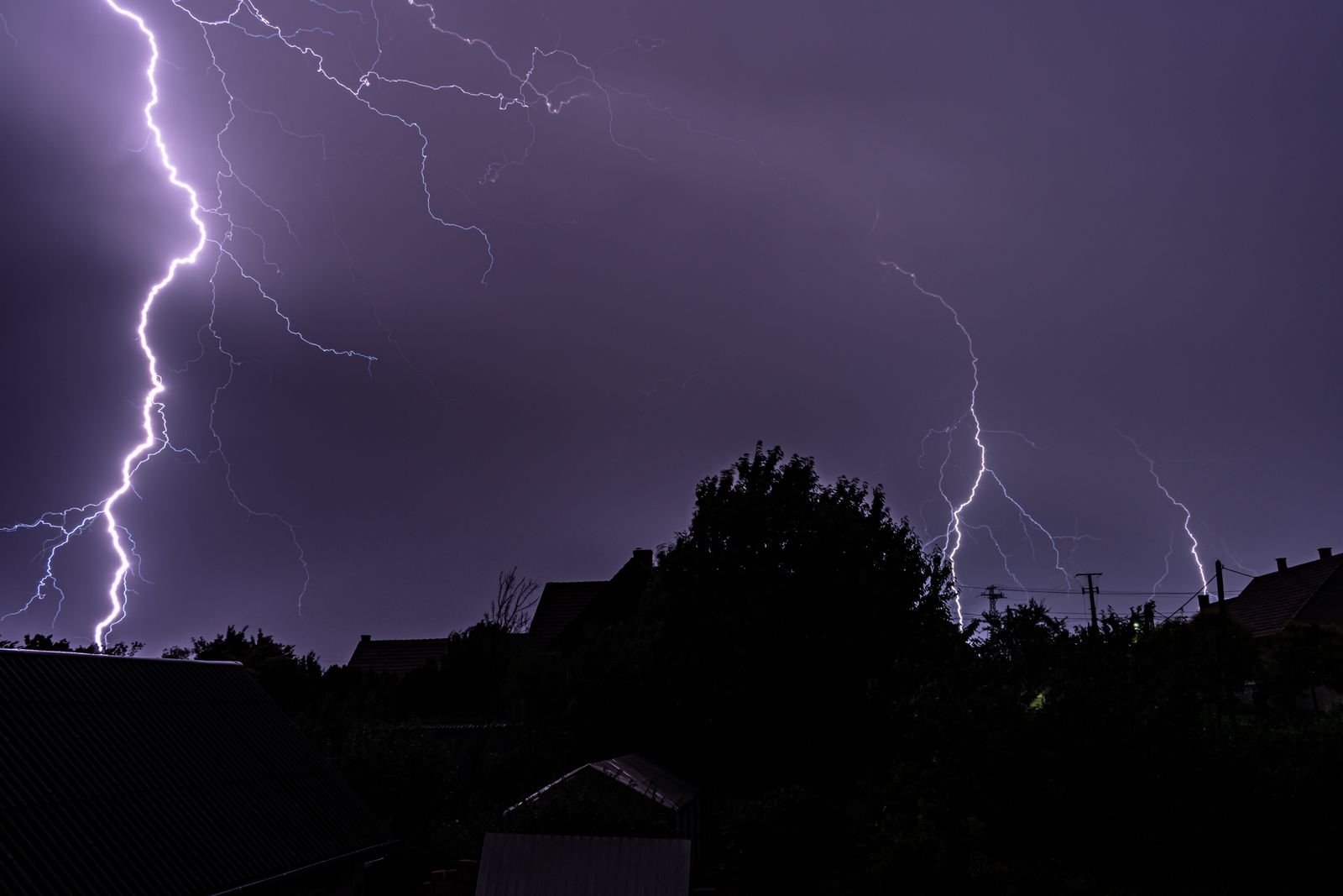 Powerful lightning storm lights up the night sky in dramatic silhouette